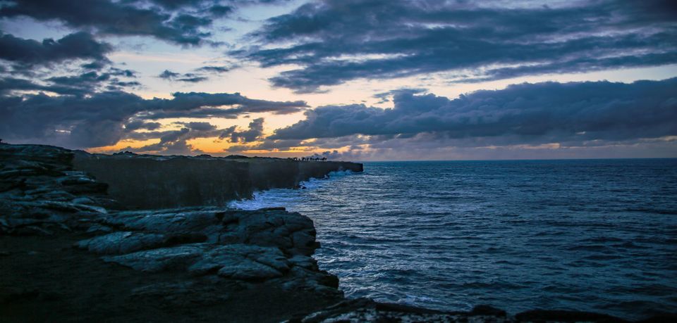 Stormy early morning, clouds rolling in over the rocky shore at Hawai'i Volcanoes National Park
