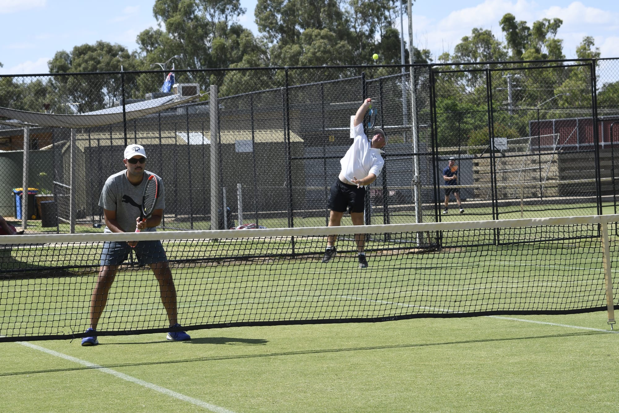 Doubles... Andrew Storer sends a serve down in his doubles match alongside Nick Ludington. 
