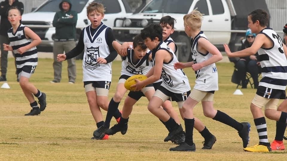 Teamwork ... Ollie Ruscoe smashes through congestion, shepherded by Kaleb Gilmour and Declan Lowden.