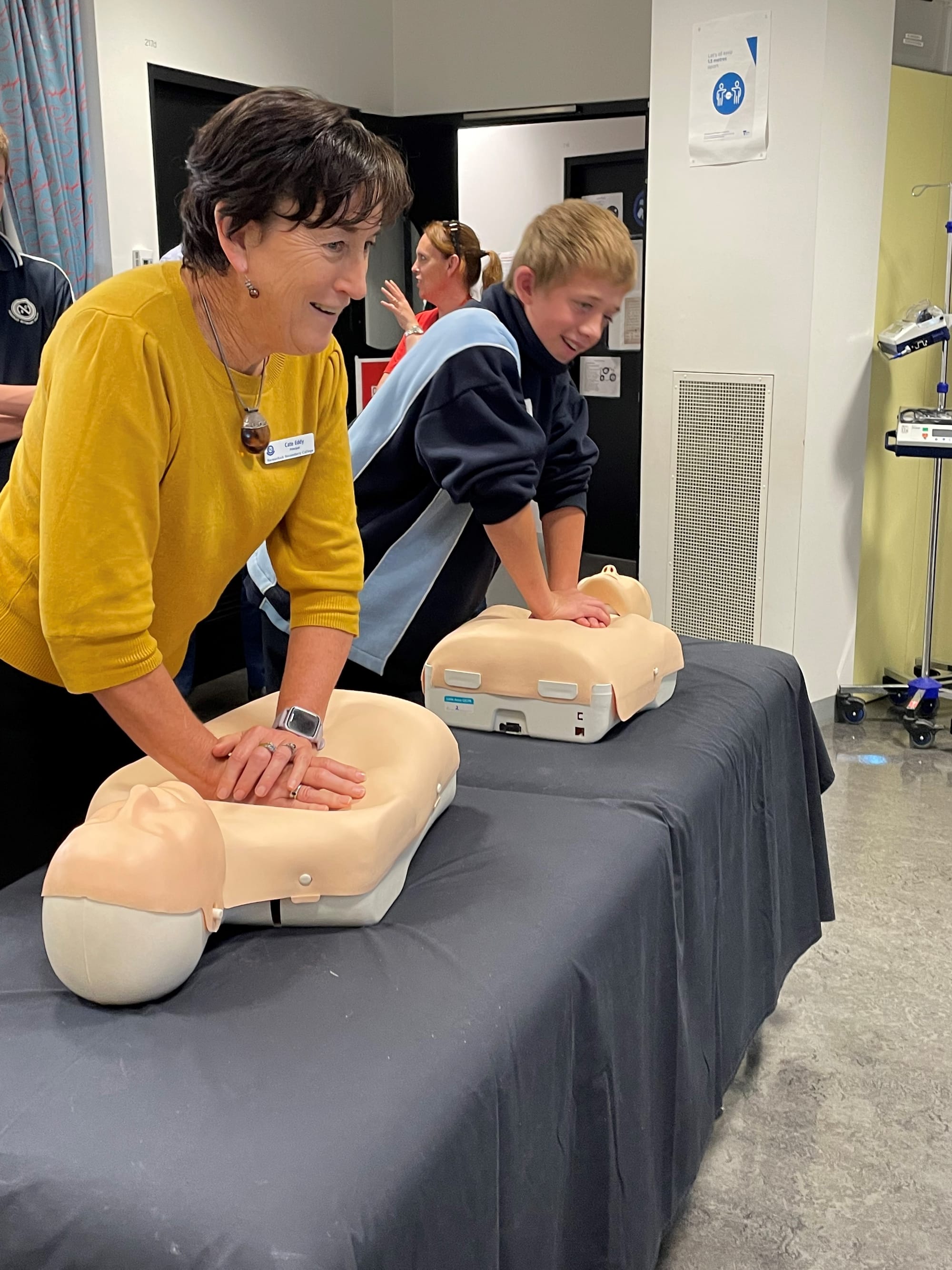 Racing to save a life... NSC principal Cate Eddy has a CPR race with student Declan Crisp.
