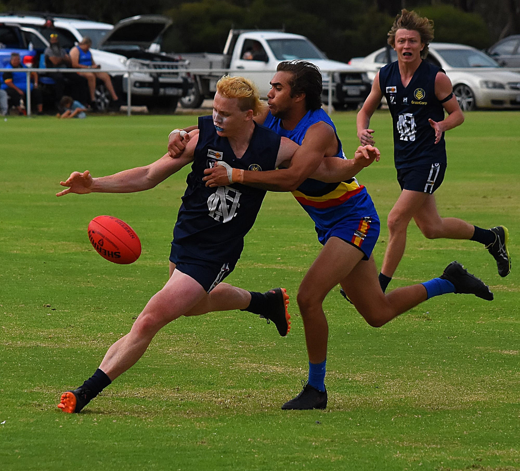 Under heat… Clancy Lester gets a kick away while being tackled.  