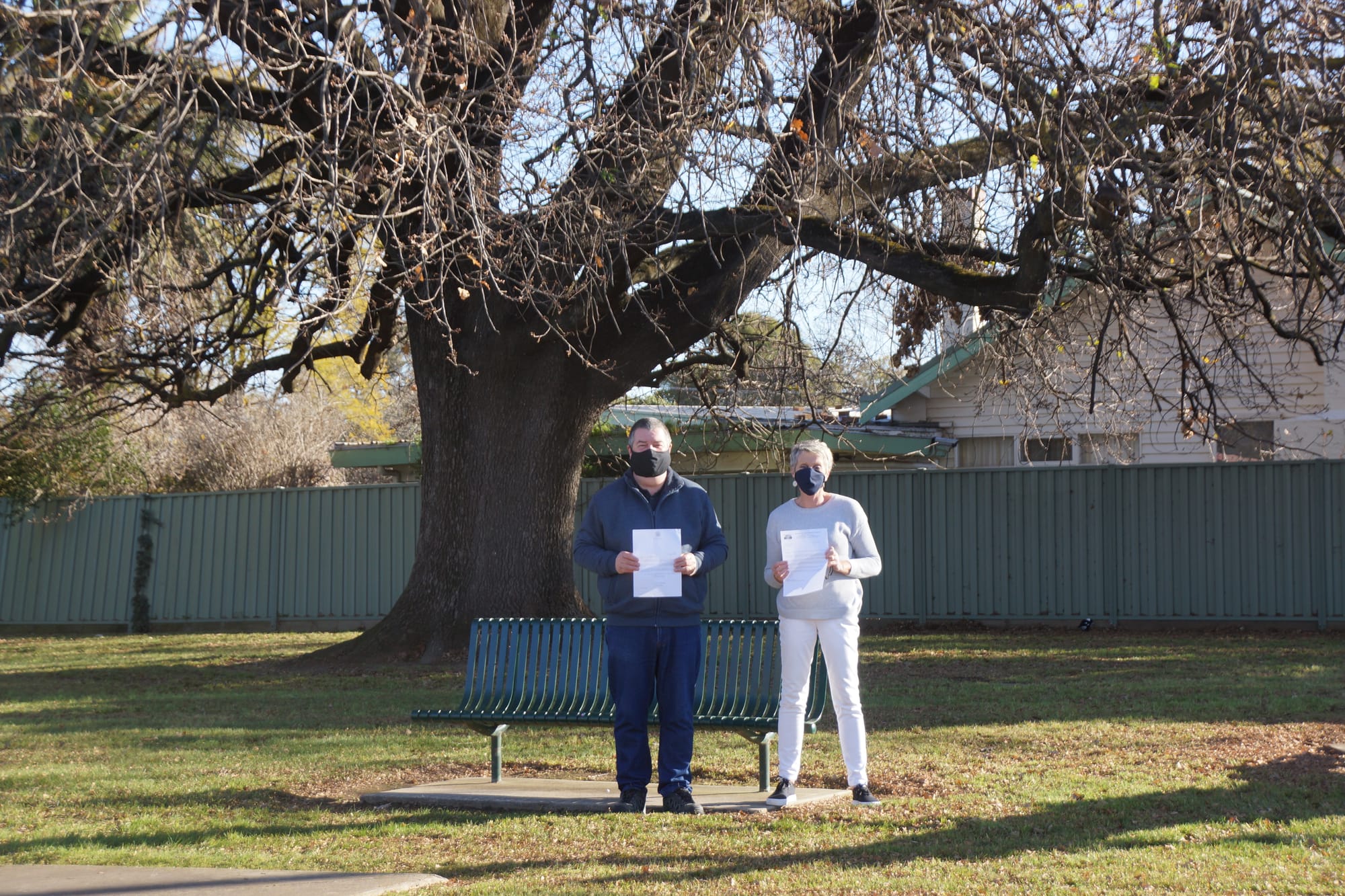 Corresponding with her Majesty ... Historical Society president Jeff Blackley and research officer Bernadette Steward under Numurkah’s mighty oak, with the letters to and from the queen. 
