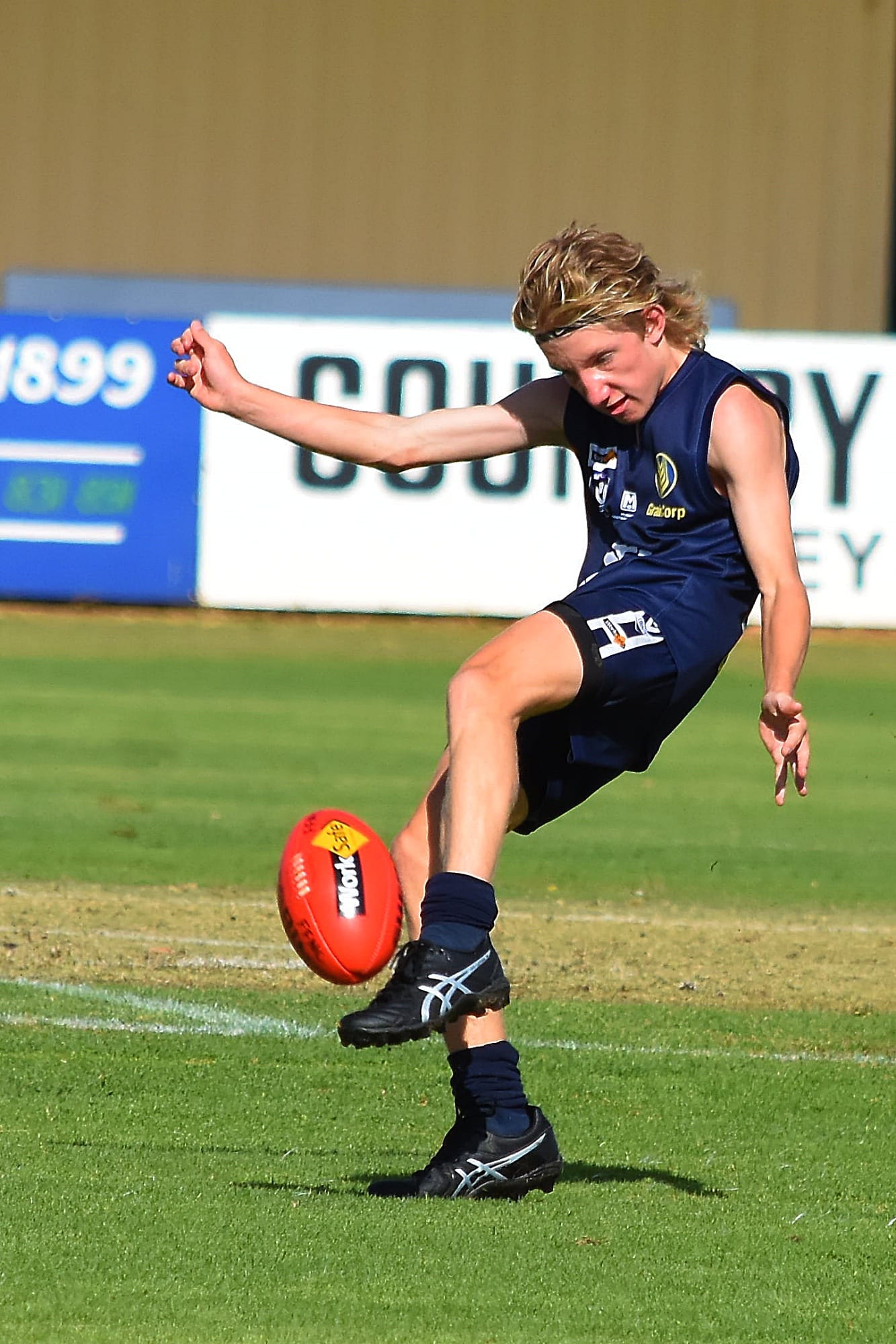 Focus... Nick Hughes throws in on the boot in the thirds.