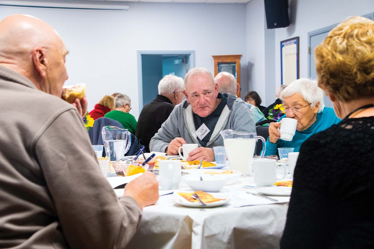 Enjoying a scone ... Don Staggard tucks in to afternoon tea at the AGM.  