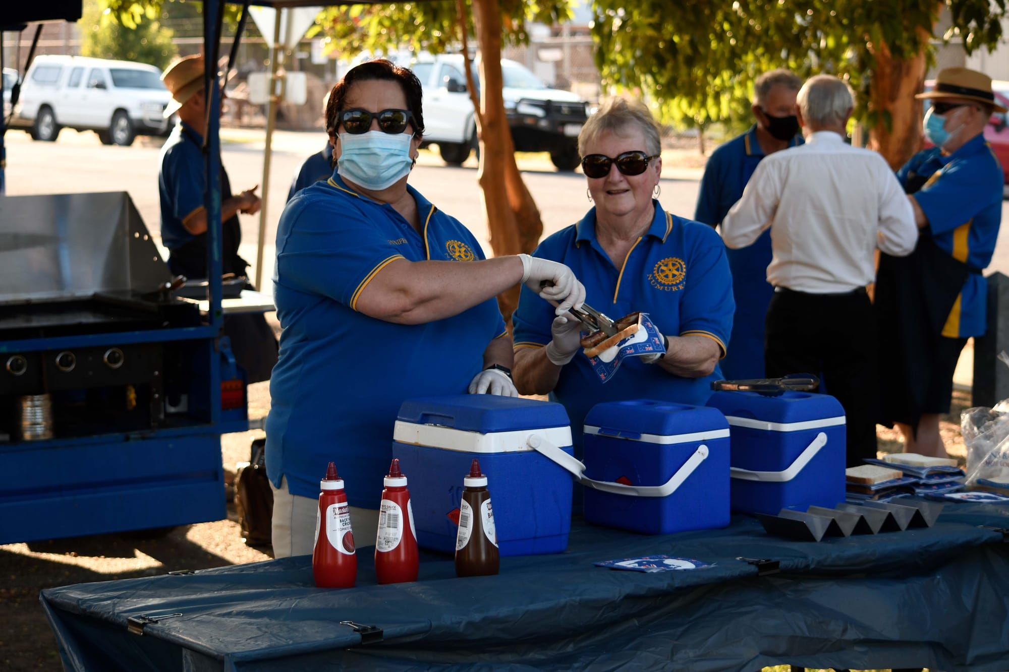 Feeding the town... Rotary Club members Jennifer Rodger (left) and Chris Hardham handed out free sausages before the ceremony began. 

