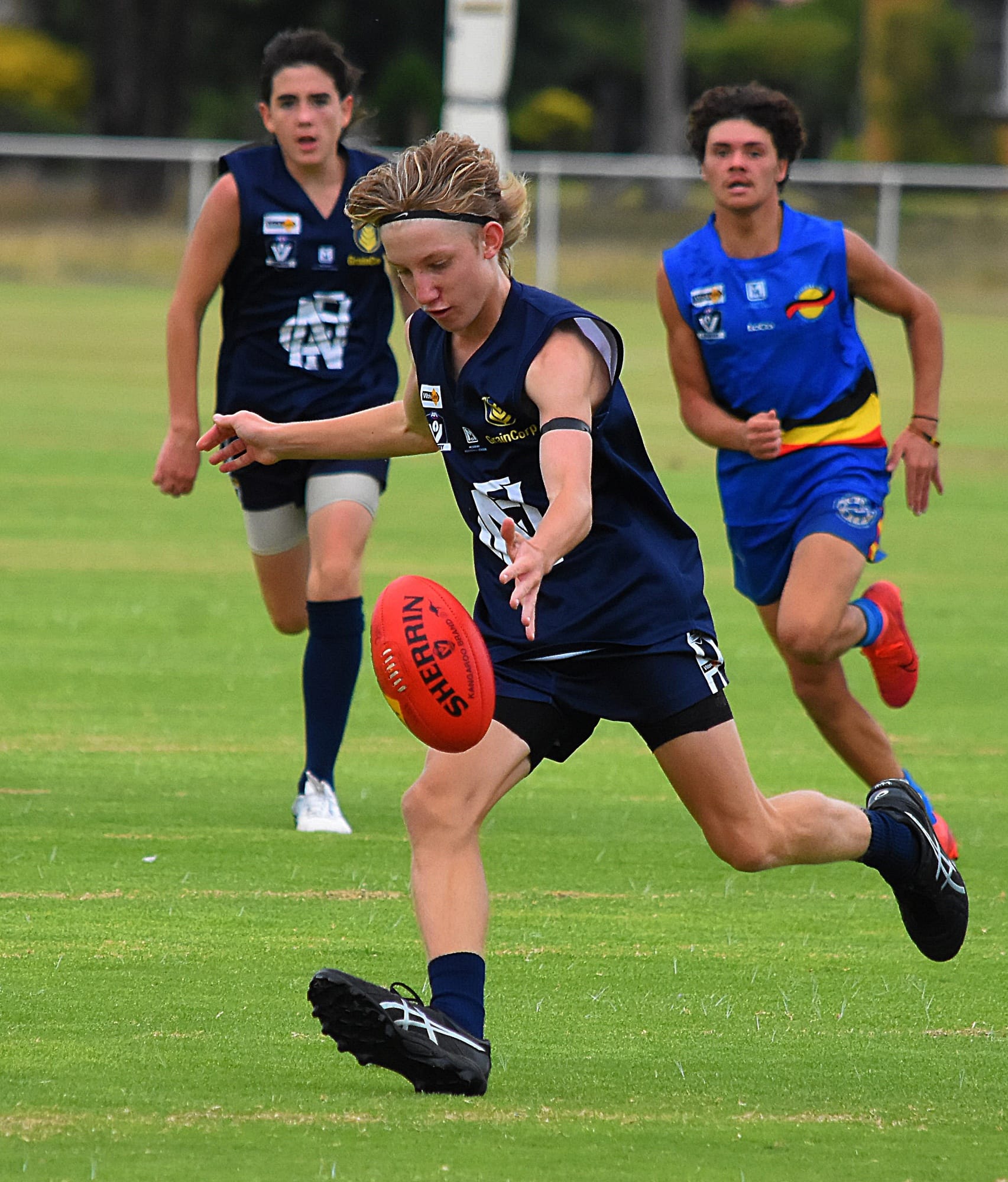 Out of there... Nick Hughes clears it from defence. 