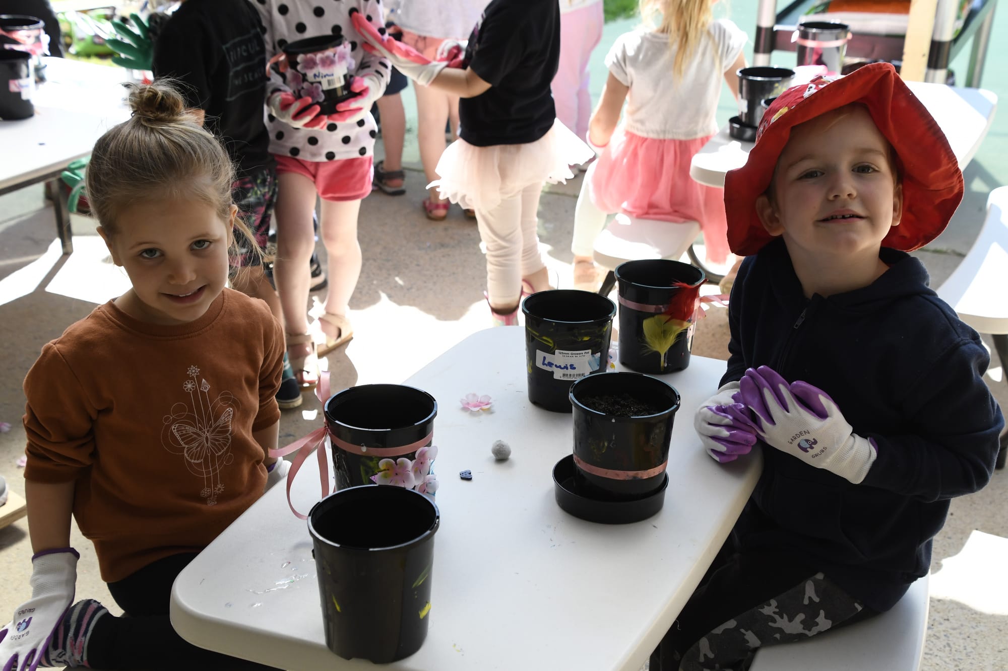 Happy planting ... Sophie Caccianiga and her friend Elijah enjoy the opportunity to plant beans and sunflowers.