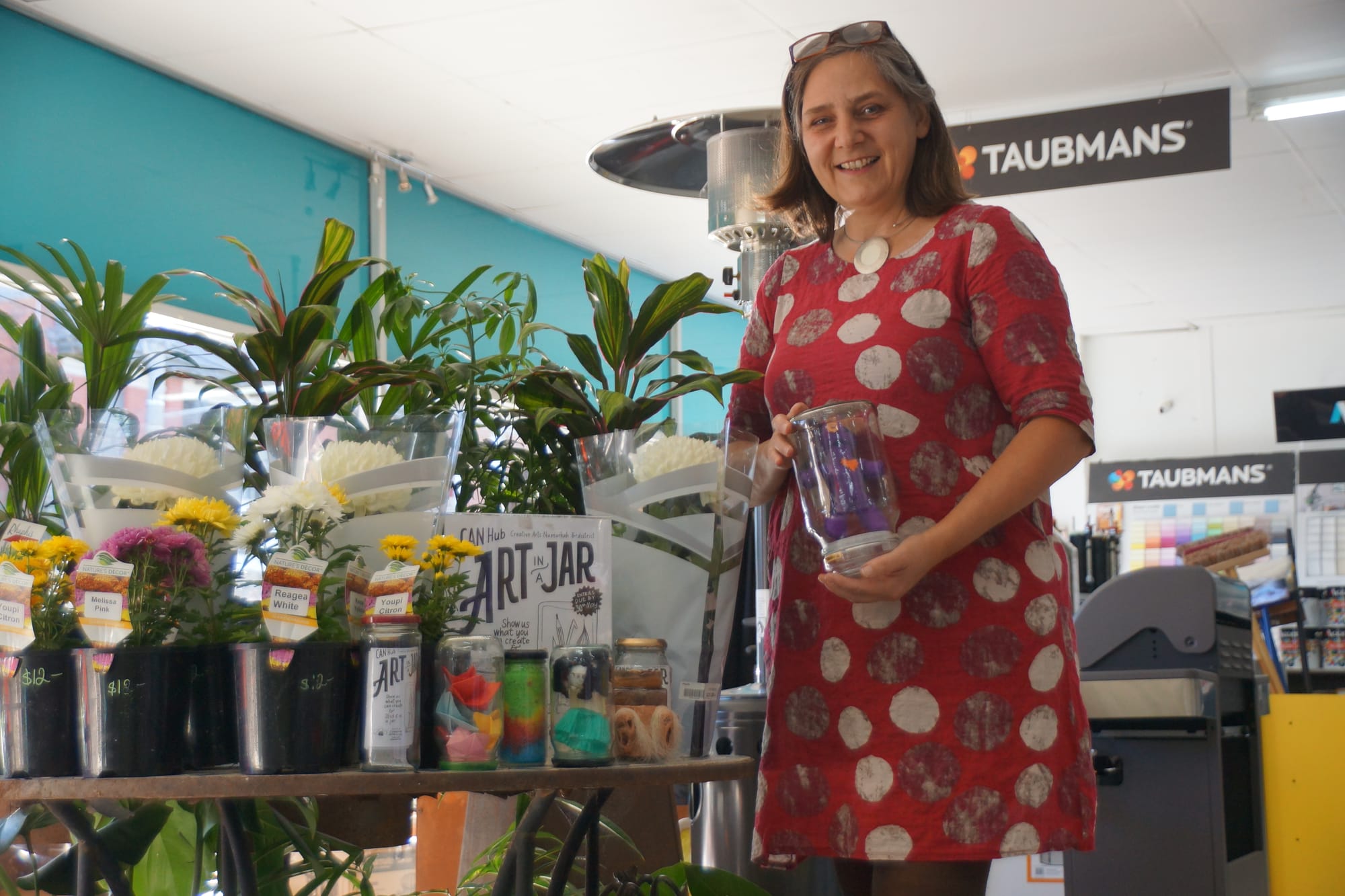 Creative juices in a jar... CAN Hub secretary Jacqueline Cuijpers with some of the artistic entries in the group’s Art in a Jar project.

