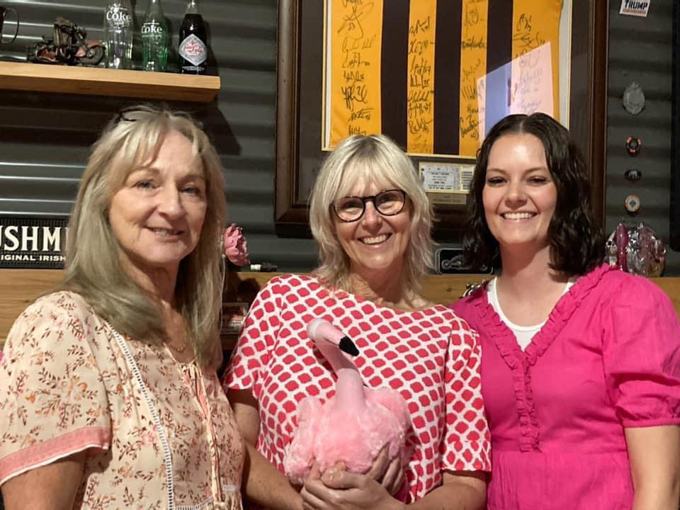 Pink ladies, and friend... Jill Bau, Donna Seiter and Jasmine Buha were having plenty of fun with a furry feathered friend at Jodie Buha’s table.
