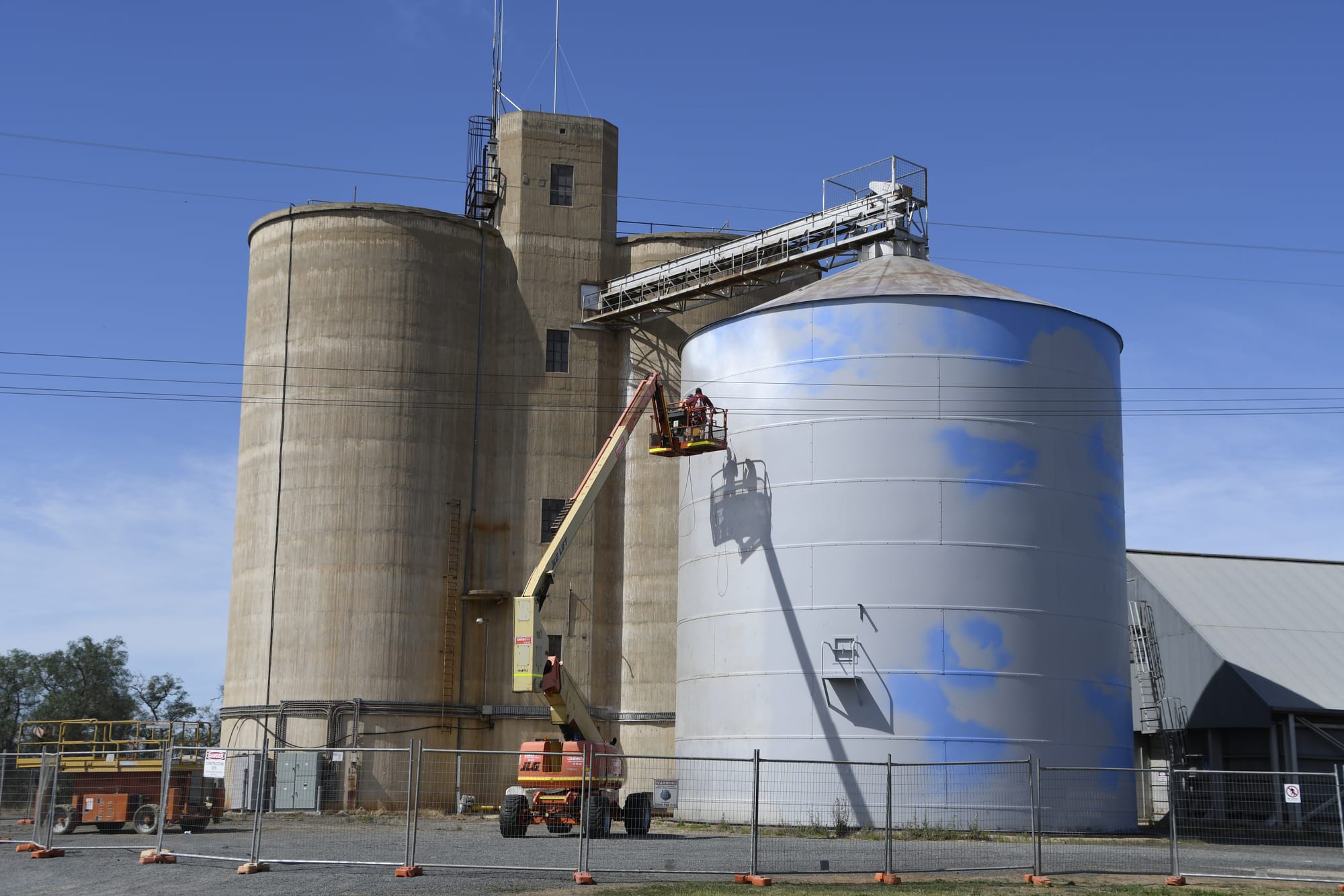 In the works ... Jimmy DVate creating his masterpiece on Picola’s metal silo.