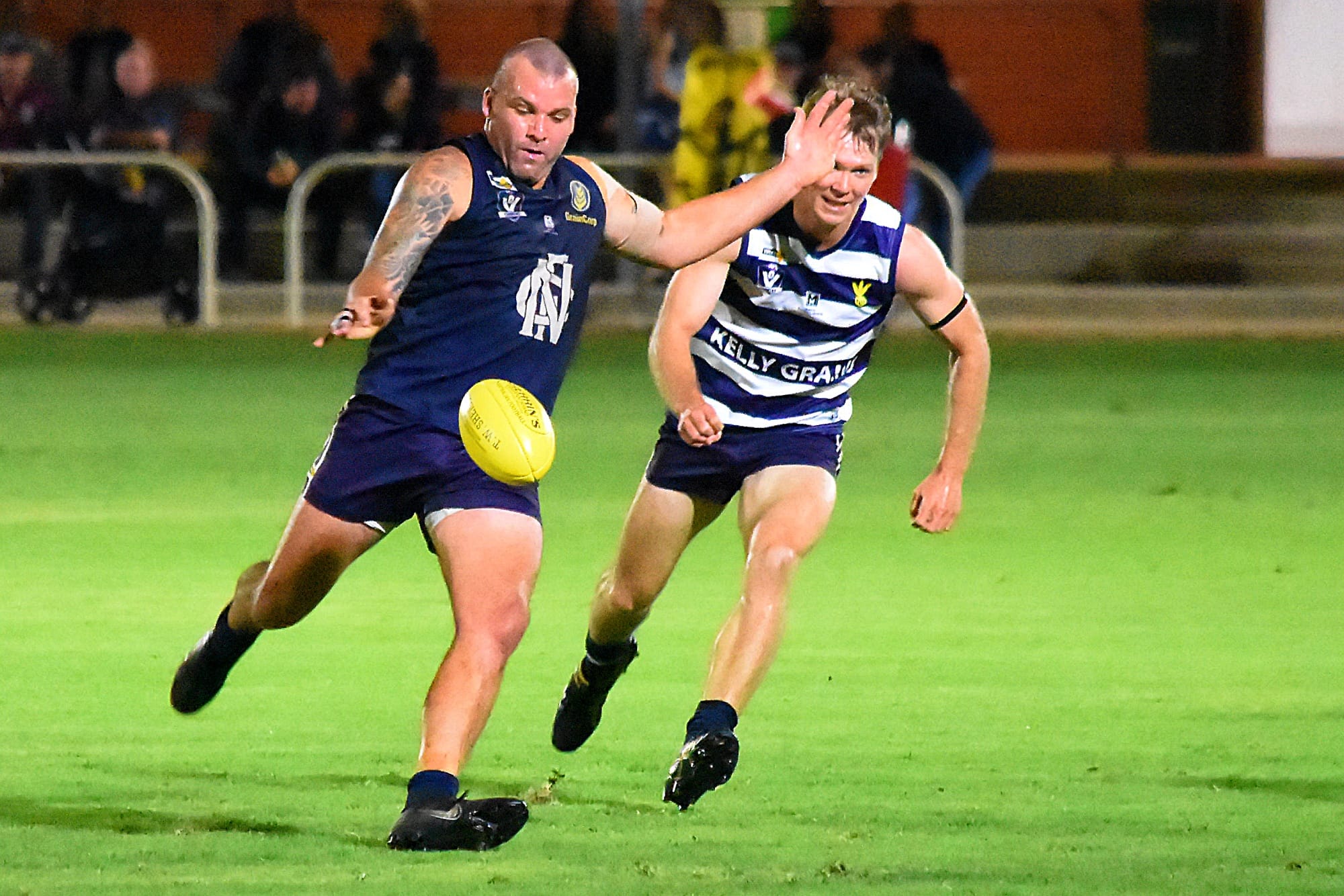 Booted away... Nathan Hicks kicks a ball under close pressure. 