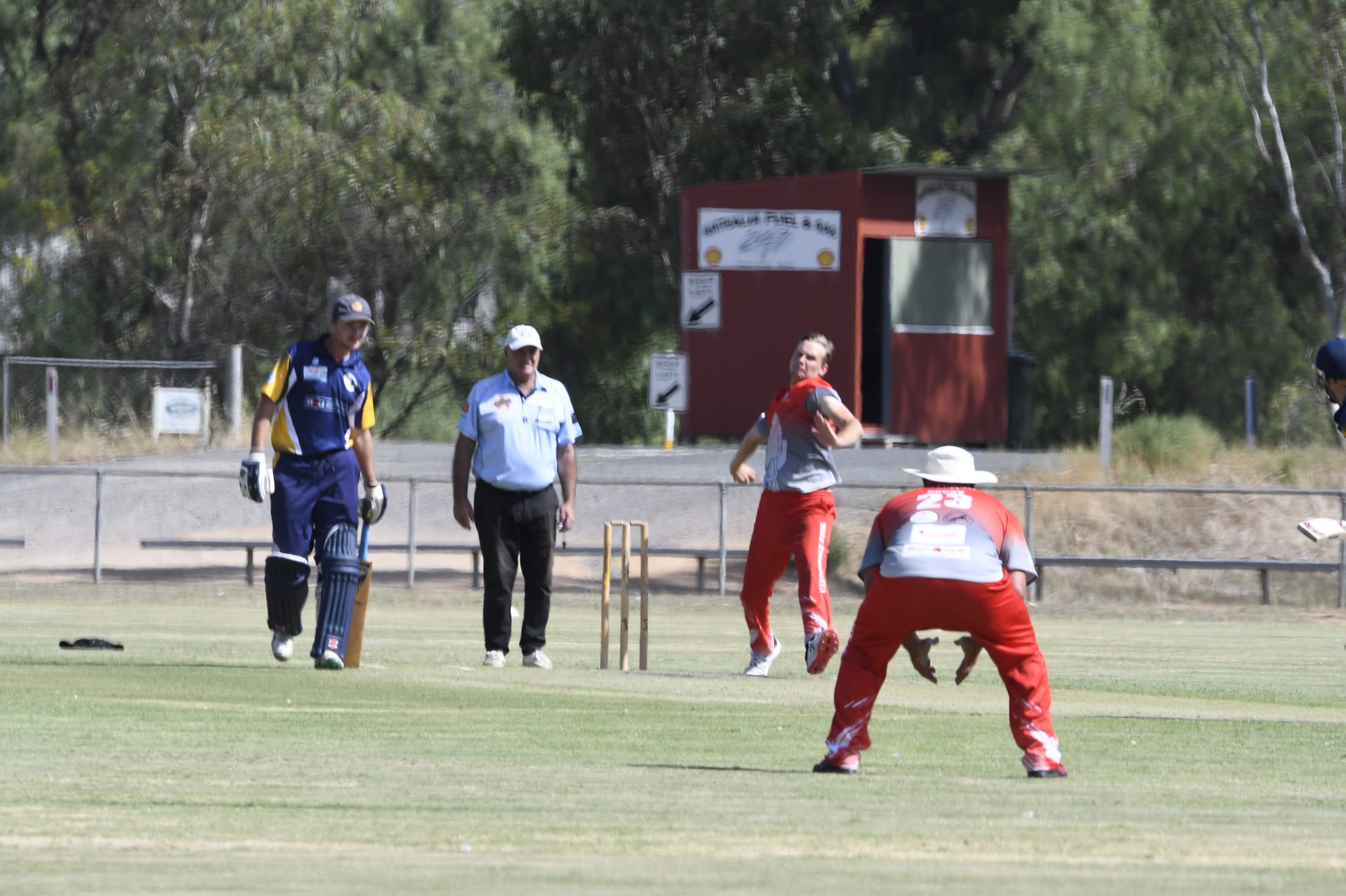 Still having a crack... Josh McFadyen steams in to bowl with Daniel Henderson waiting in the gully. 
