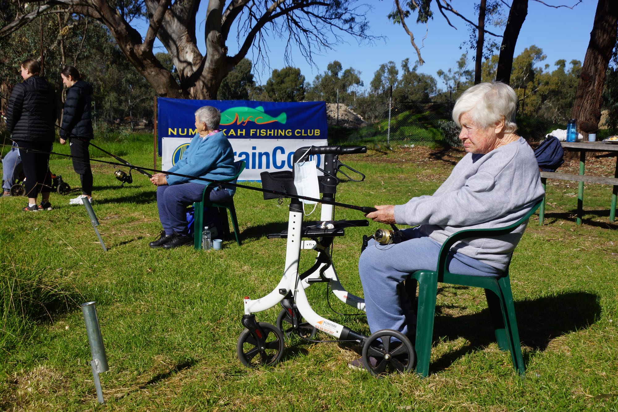 Relaxing... Jan Thomas (left) and Flo Goodwin soaking in the sunlight behind their rods. 
