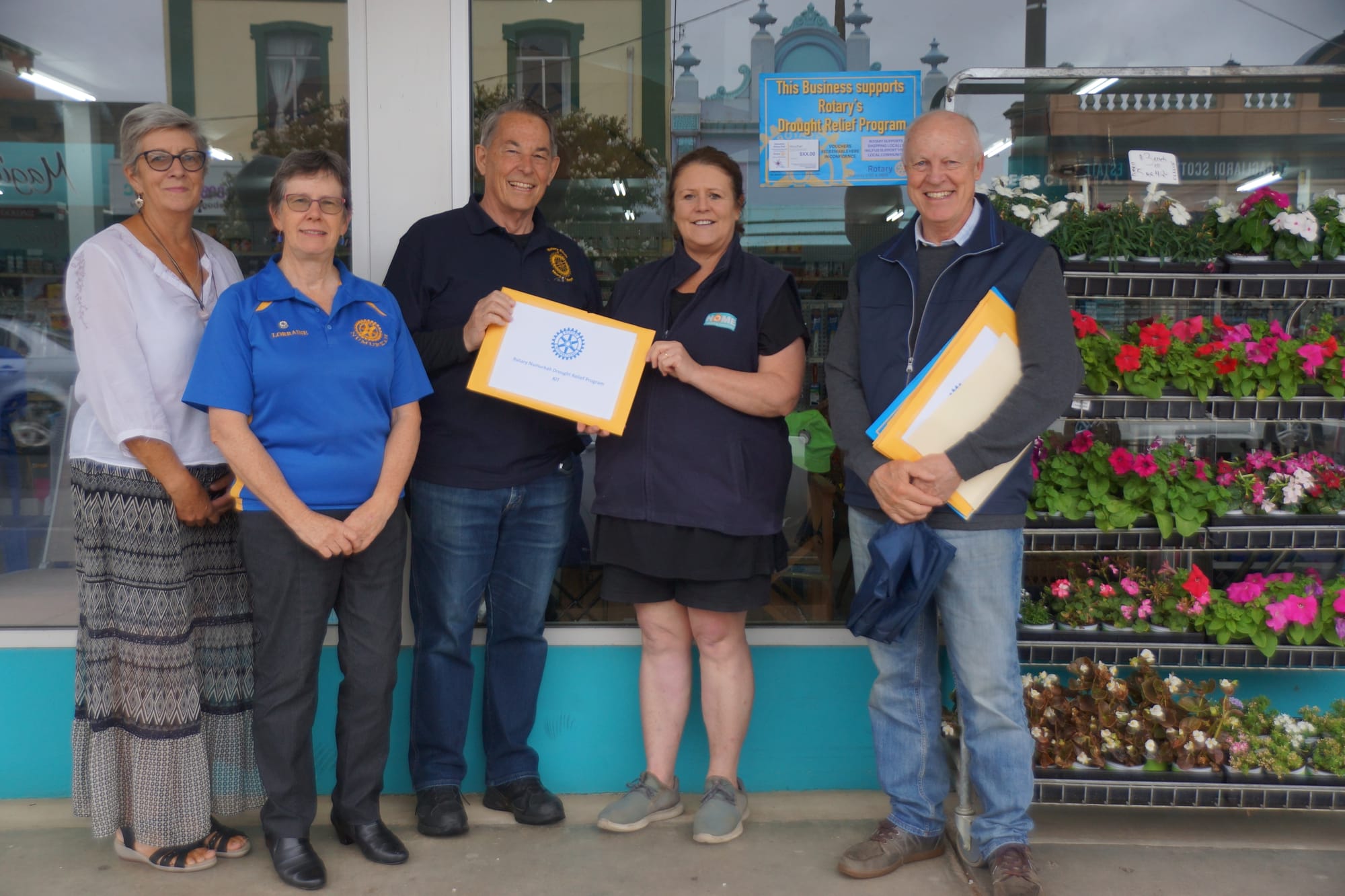Help is at hand ... (From left): Kaye Moodie and Lorraine Greenwood from Rotary Club of Numurkah, Geoff Haddy from the Rotary Club of North Balwyn presenting an information pack to Gayle Buzza from Numurkah Home Timber and Hardware, and Rob Head from Rotary Club of North Balwyn.