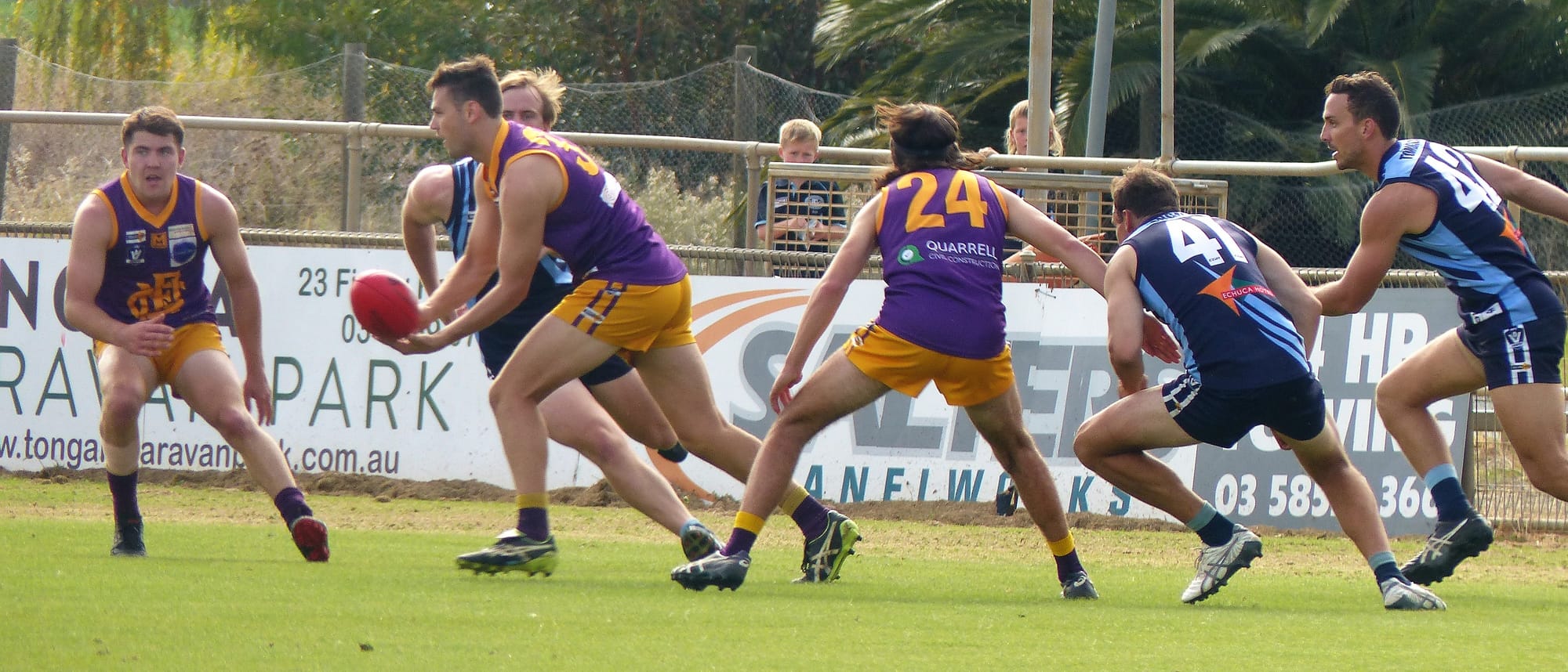 Dishing off... Liam Evans gives a handball off to a runner.