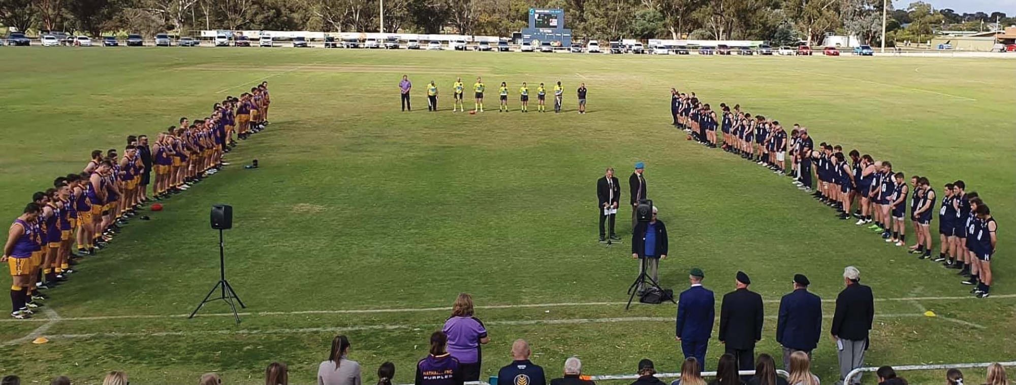 Lest we forget ... Players, coaches, umpires and supporters stood for a minute’s silence before the game. 