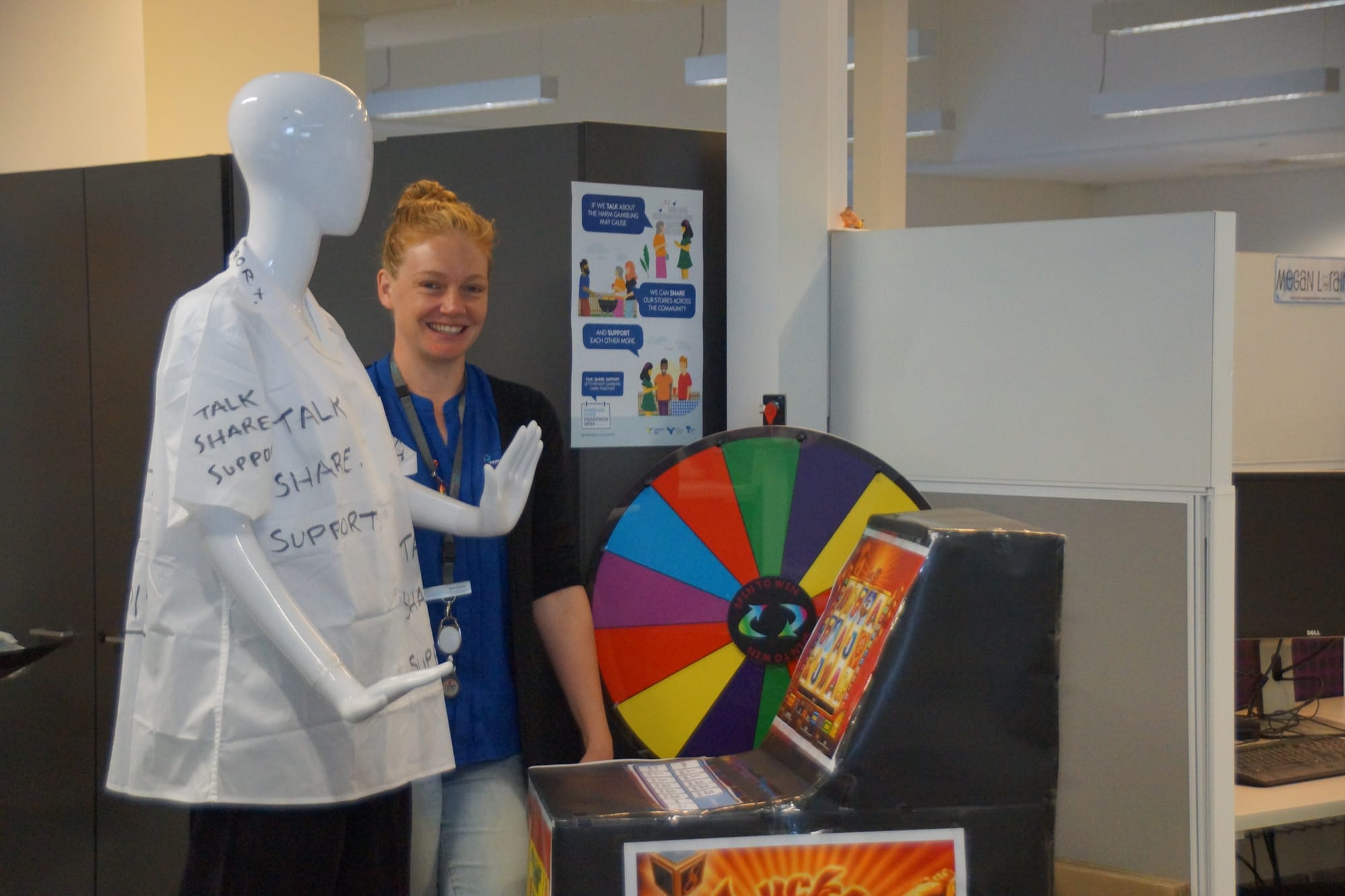 Hoping to start a conversation ... Gamblers Help worker Sam Spinks with a display depicting various types of gambling.