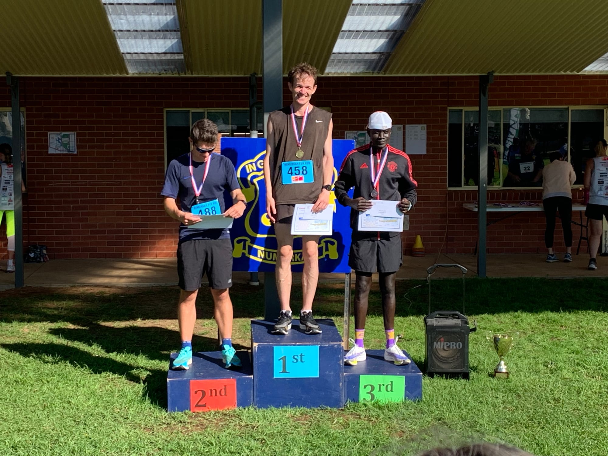 Tired but happy... (From left): Adam Burbidge, Robert Bray and Abraham Awan gave it their all in the Open Male 10km race to earn a place on the podium.
