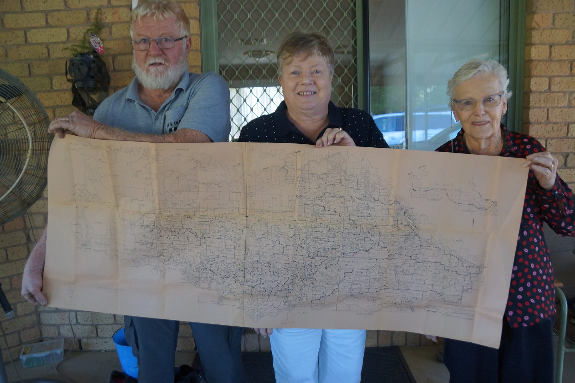 History lives on... Original soldier settler Hazel Boase (right) with son Geoff and daughter Cheryl, holding up a map of the Soldier Settlement Scheme block allocation map. 
