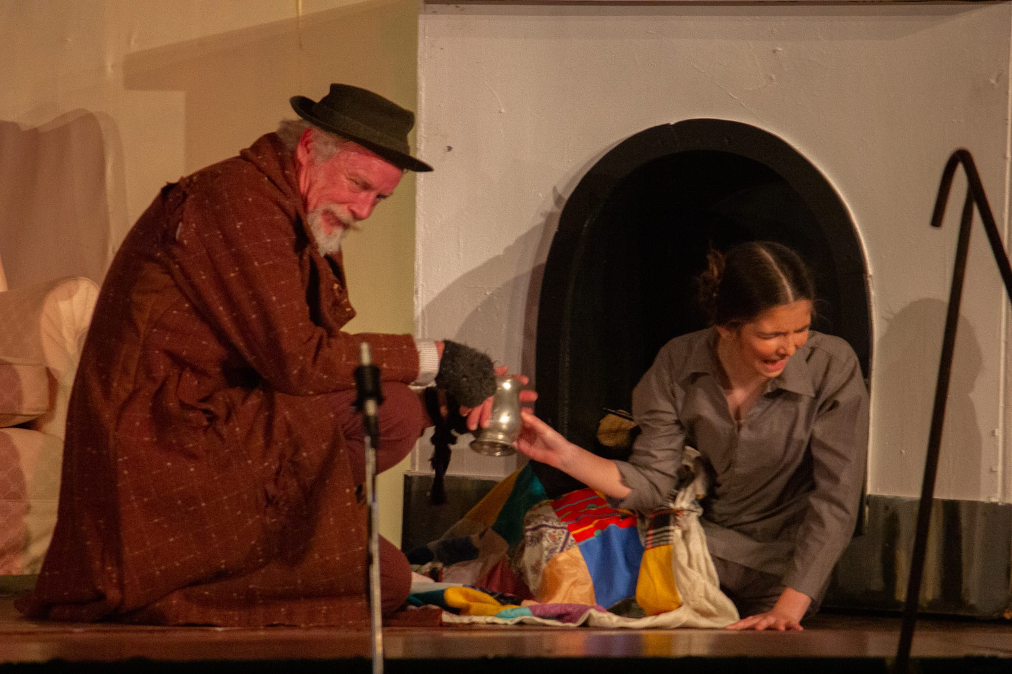 Have a drop of gin - Fagin (Bernie Cook) offers Oliver (Taylee Branch) a wee nip of the hard stuff.