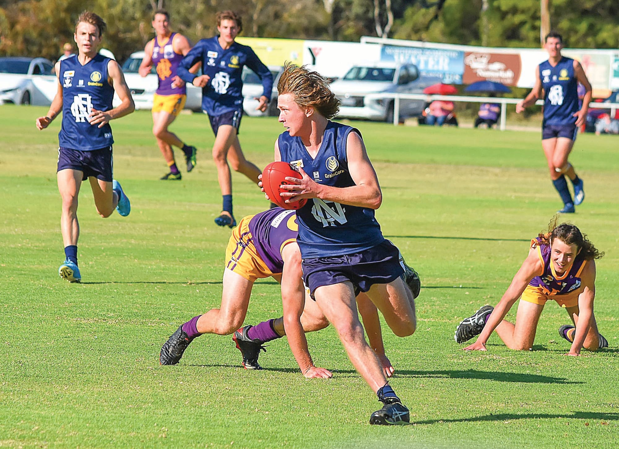 On his bike... Ben Millen scoots away from would-be Nathalia tacklers going to ground. (BP)