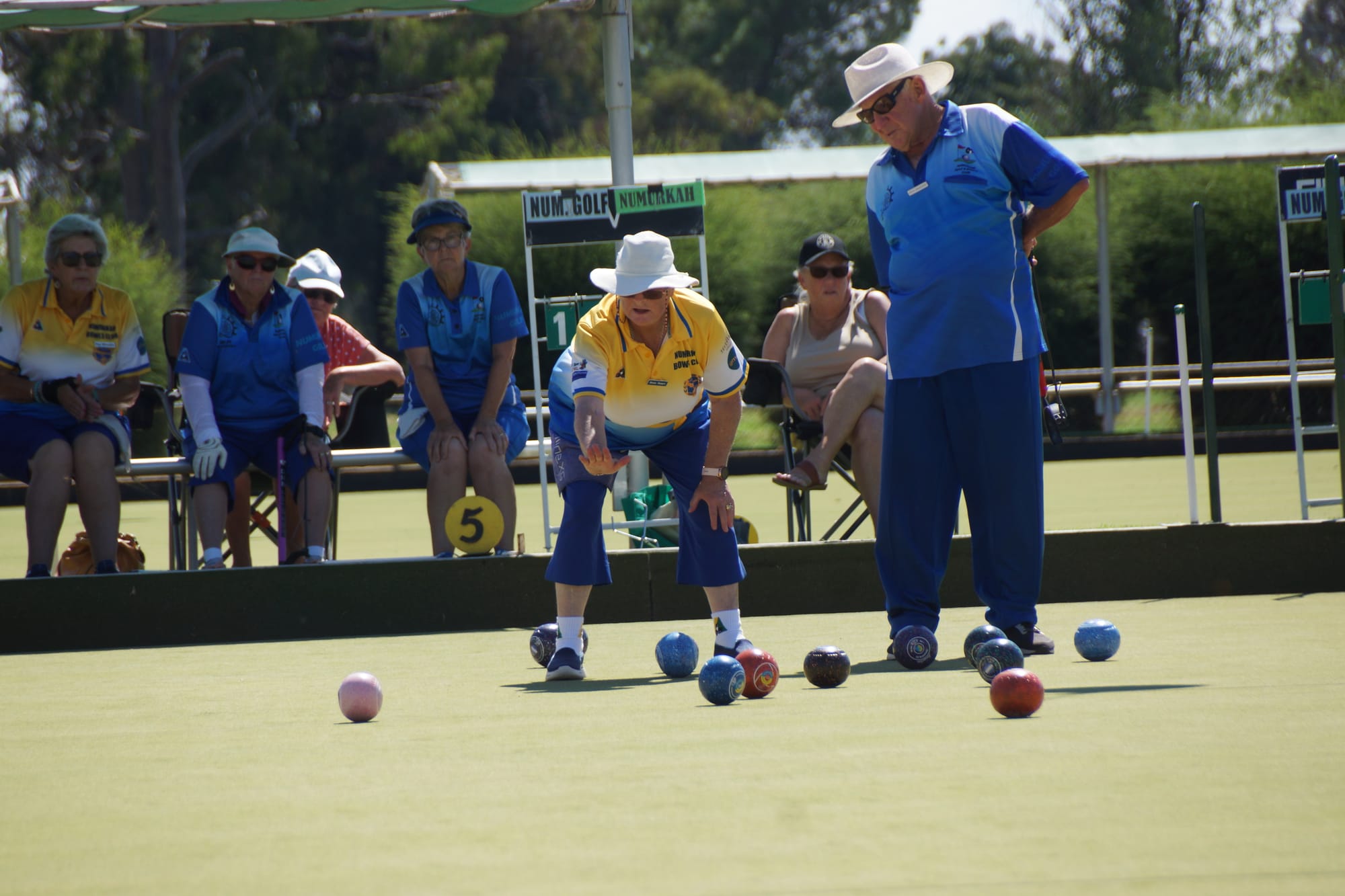 Stop there... Town’s Jenny Stuart wills the bowl to slow down last Friday, with Golf’s Kevin Saunders watching on. 