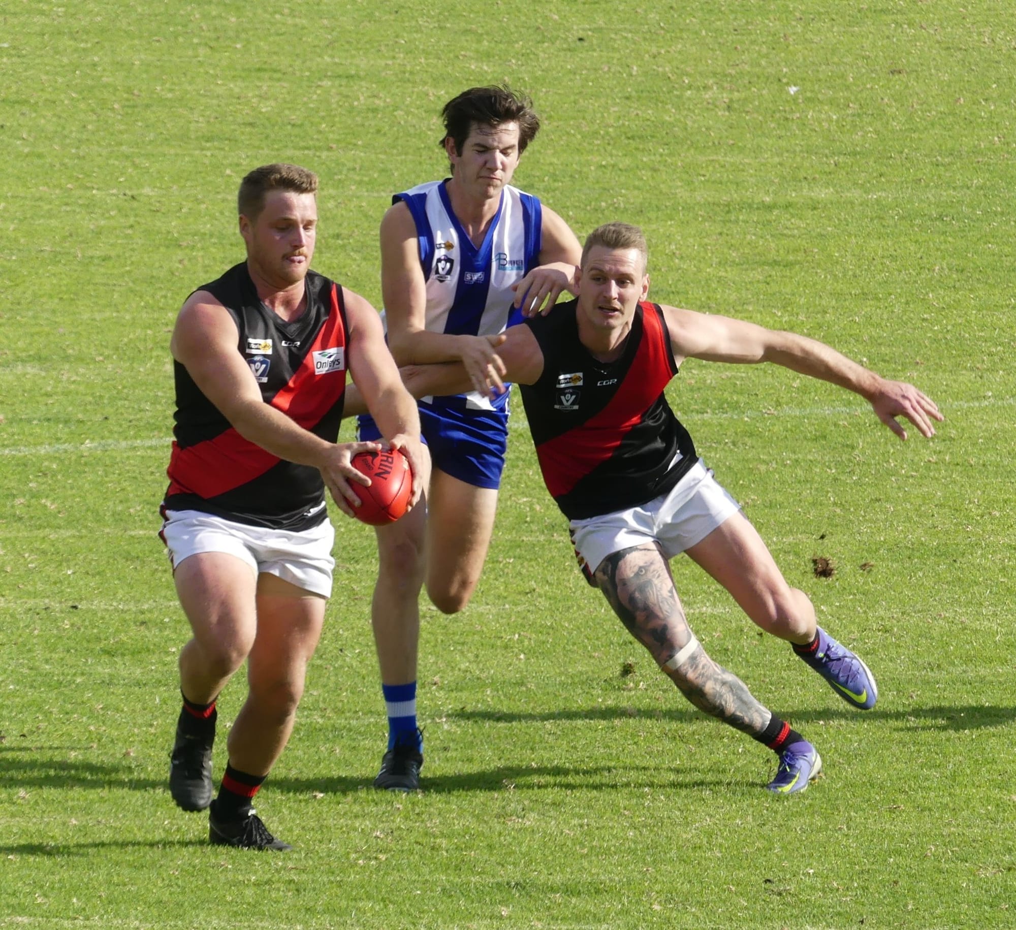 Teamwork... Lachie Wright gets a kick away while Charlie Burrows puts on a block on for him. 
