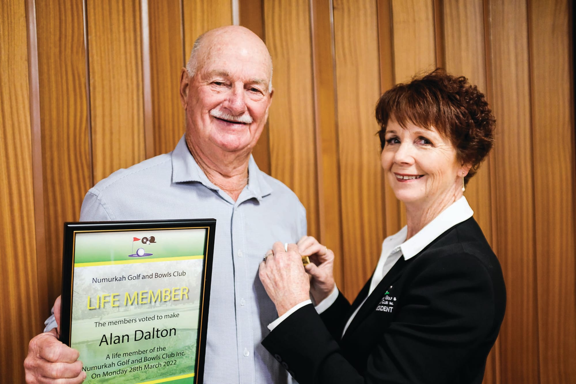 In everything… Alan Dalton receives his life membership badge from Numurkah Golf and Bowls Club president Beverley Hutchins.