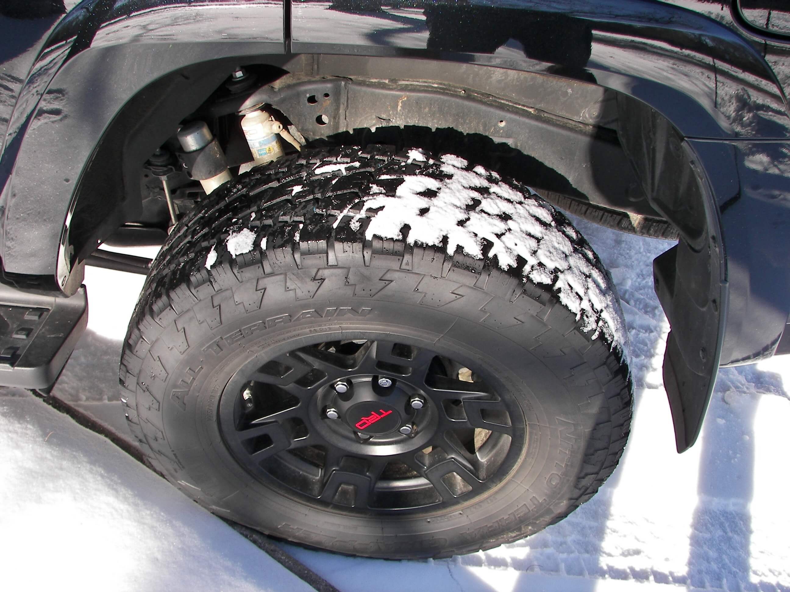 2017 Toyota 4Runner TRD Pro: Nitto Grappler A/T tires mounted on 17' matte black alloys take 6-bolts to mount to a live axle with E-LSD; silver Bilstein shock absorbers feature a separate reservoir for improved fluid cooling and 10" additional wheel articulation.
