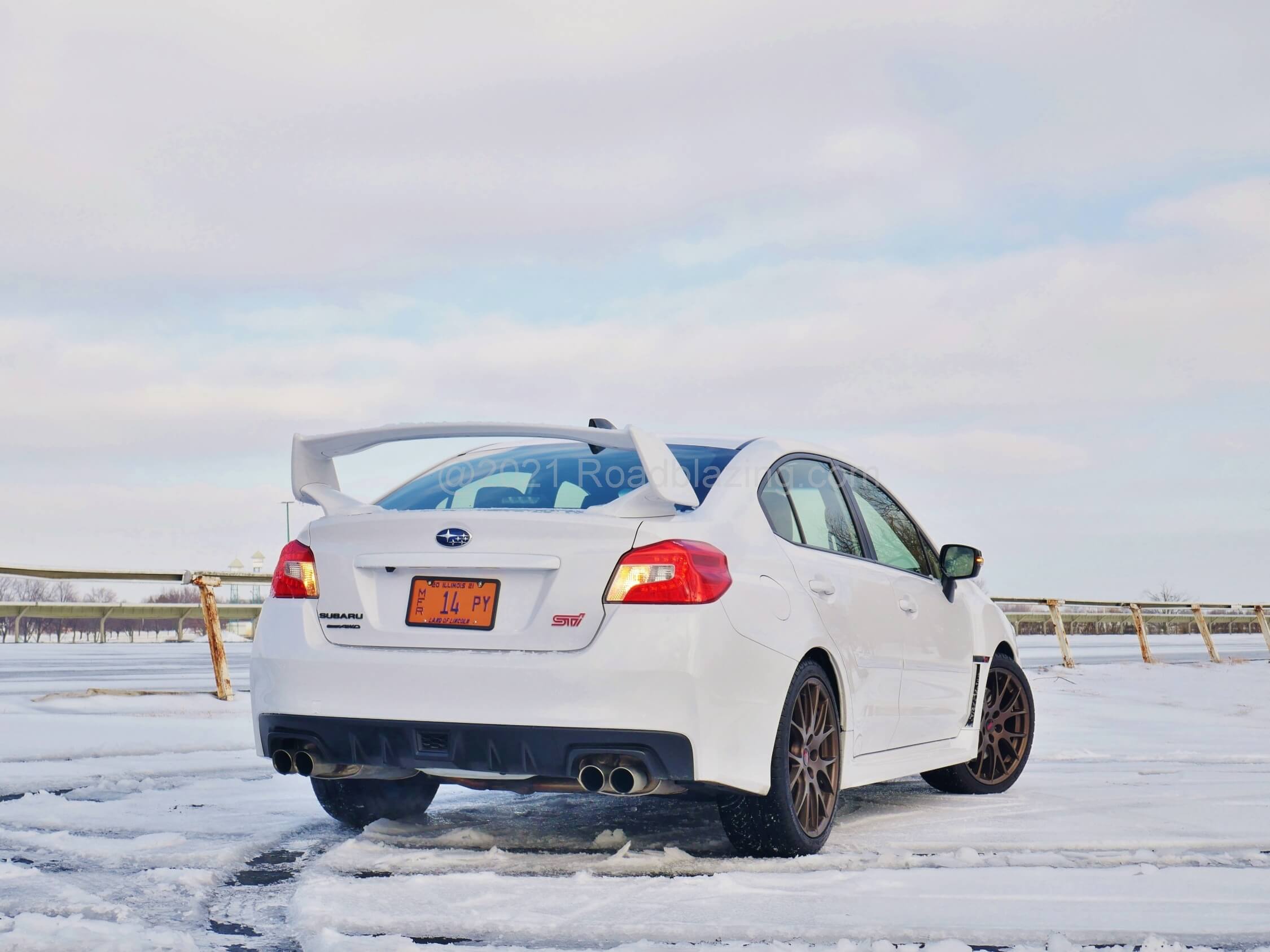 2020 Subaru WRX STI: All trim is darkened, there's a lower rear diffuser and STI exhaust is lower backpressure 3.0" tubular stainless steel exiting quad pipes.