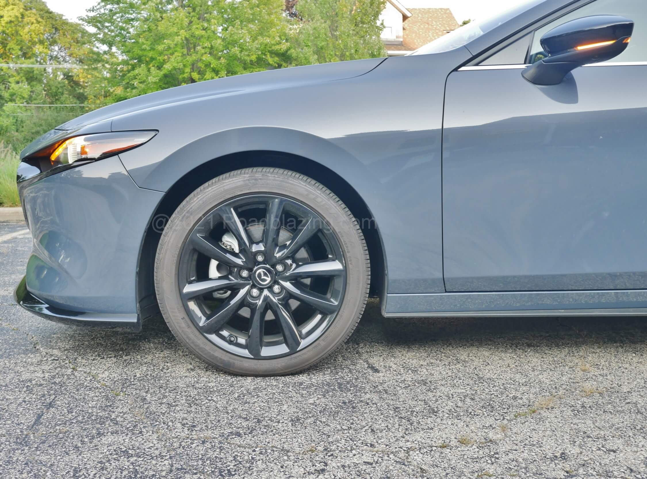 2021 Mazda 3 2.5 Turbo Hatchback: having slightly lower clearance than the sedan suits a ride that responds taut without harshness. Steering isn't excessively hefty and transmits road grip.