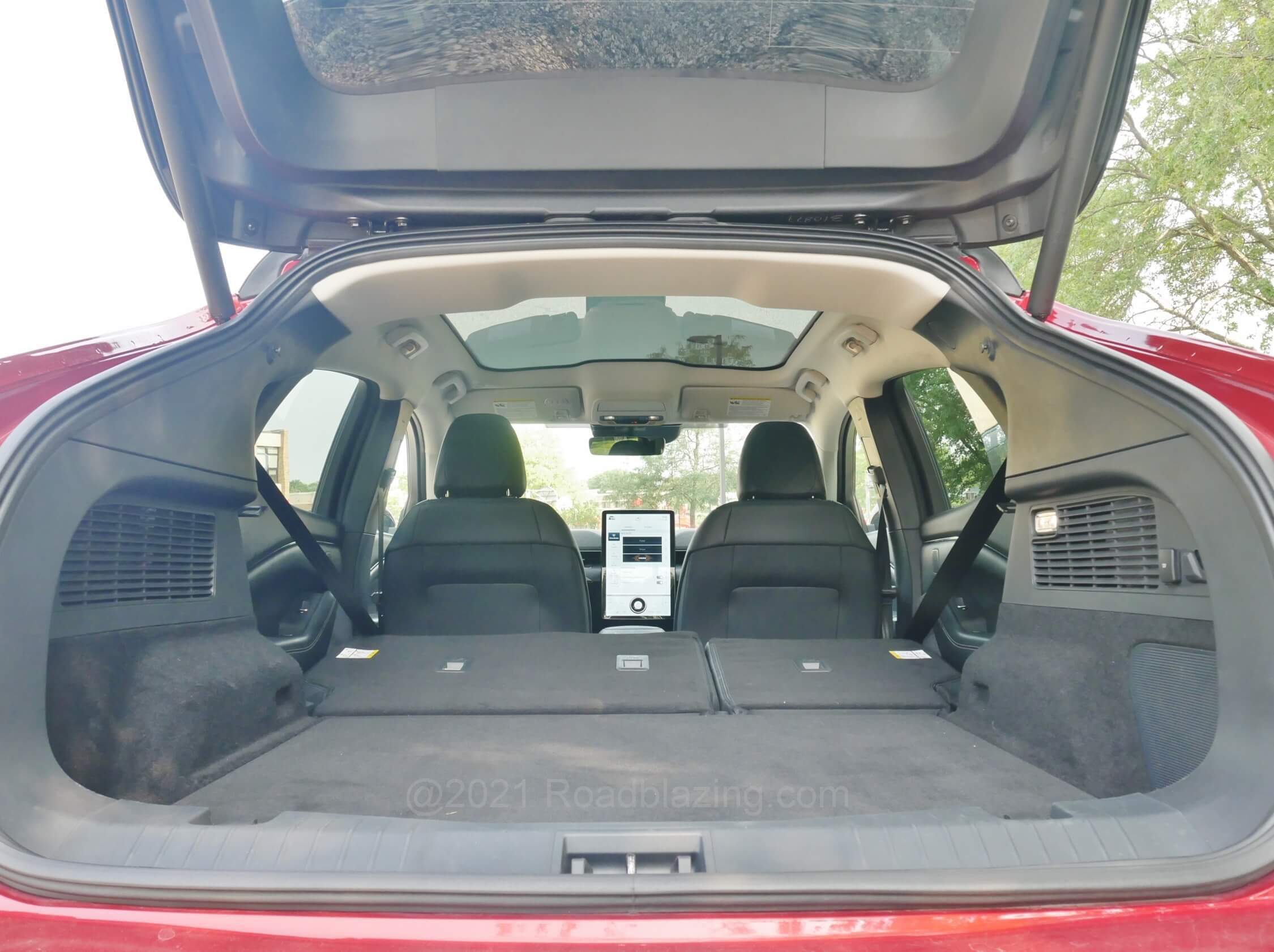 2021 Ford Mustang Mach-E Premium AWD: wide + tall load aperture open to cargo area finished with tight nap carpeting