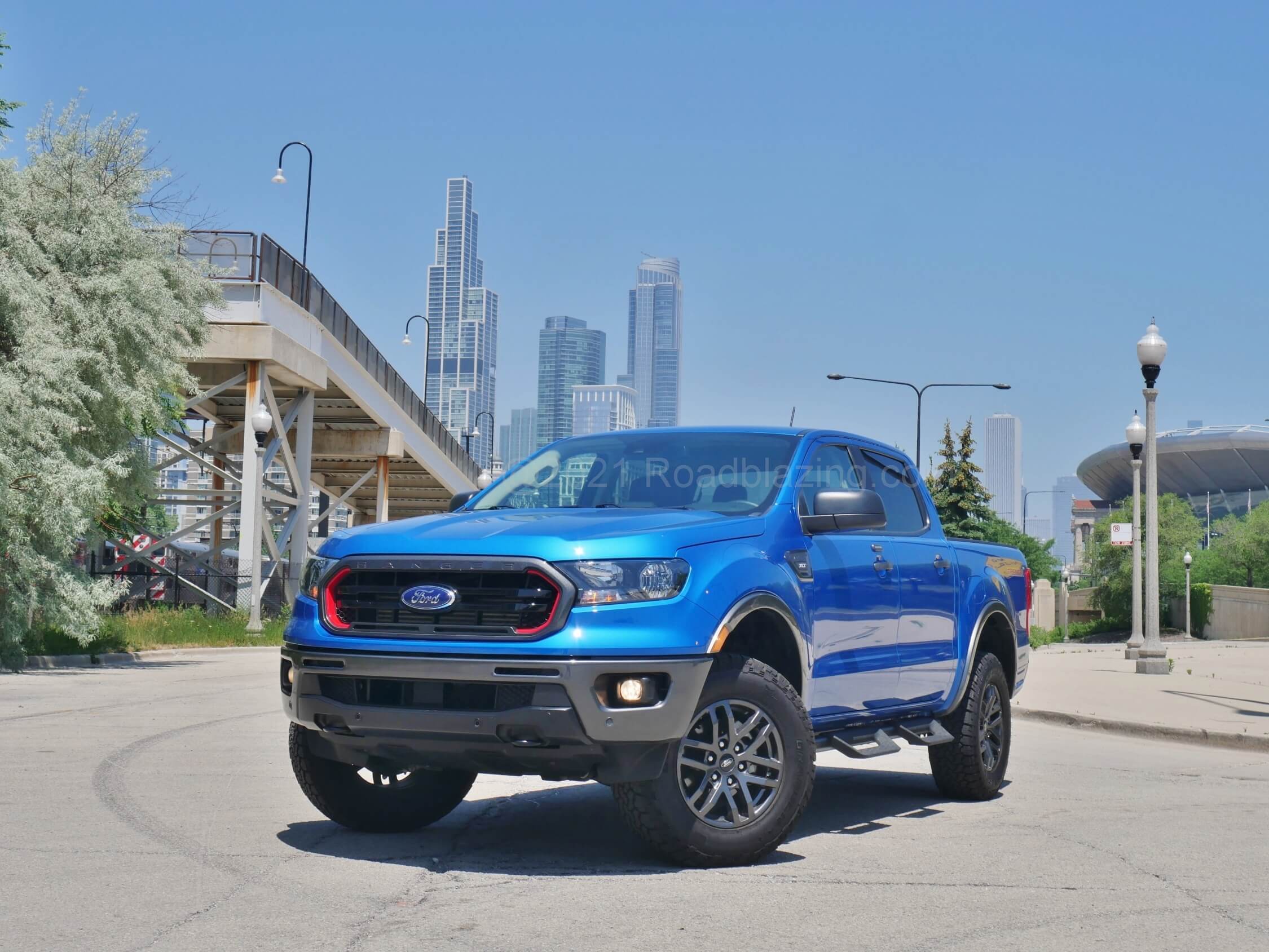 2021 Ford Ranger SuperCrew XLT Tremor 4x4: featuring the brand's current crossover wide hexagon grille, yet with unique red borders and graphite bumpers and body cladding