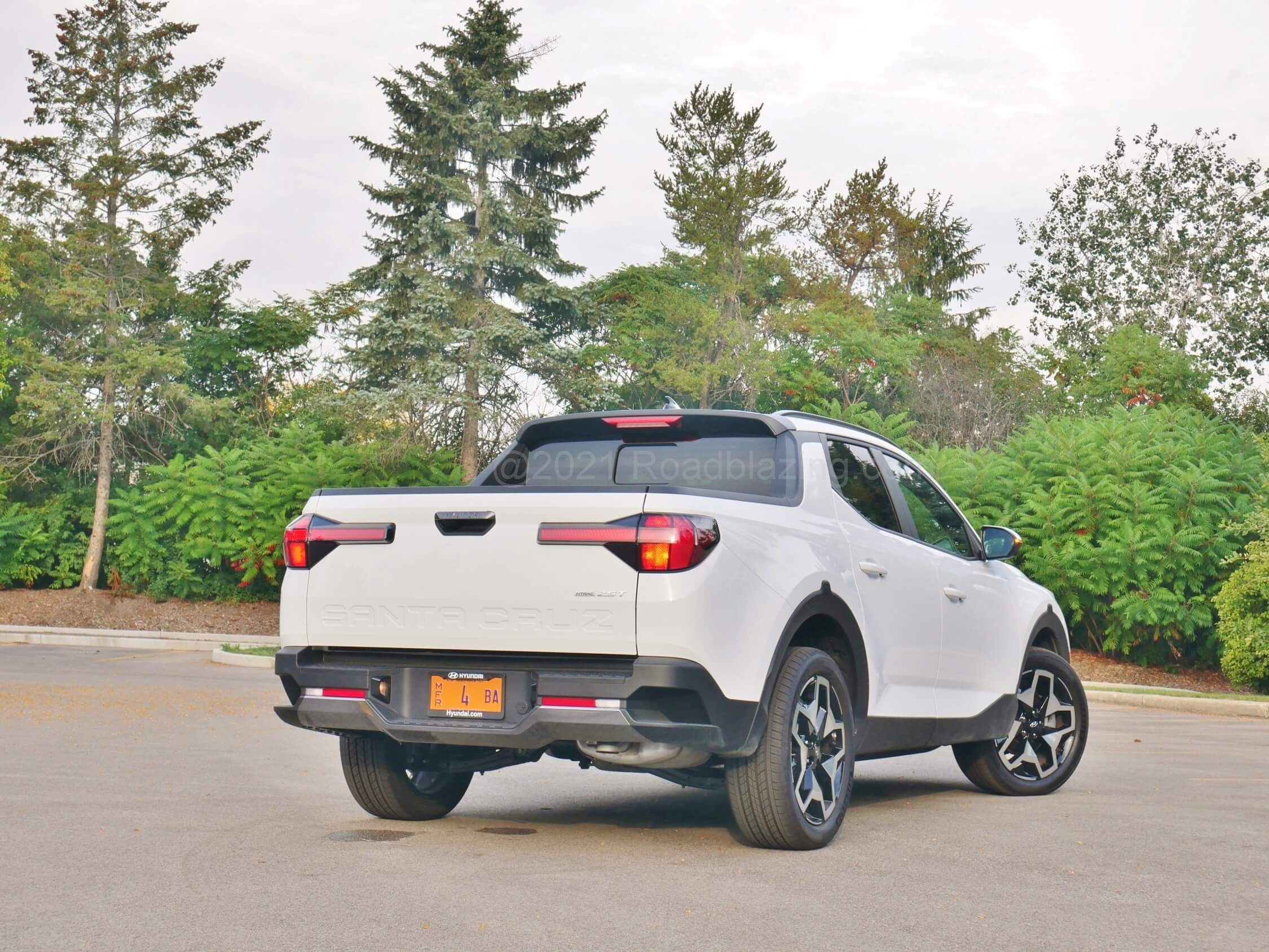 2022 Hyundai Santa Cruz 2.5T Limited AWD: rear tailgate sports lateral stingray LED array while rear bumper is dressed rugged with integrated steps.