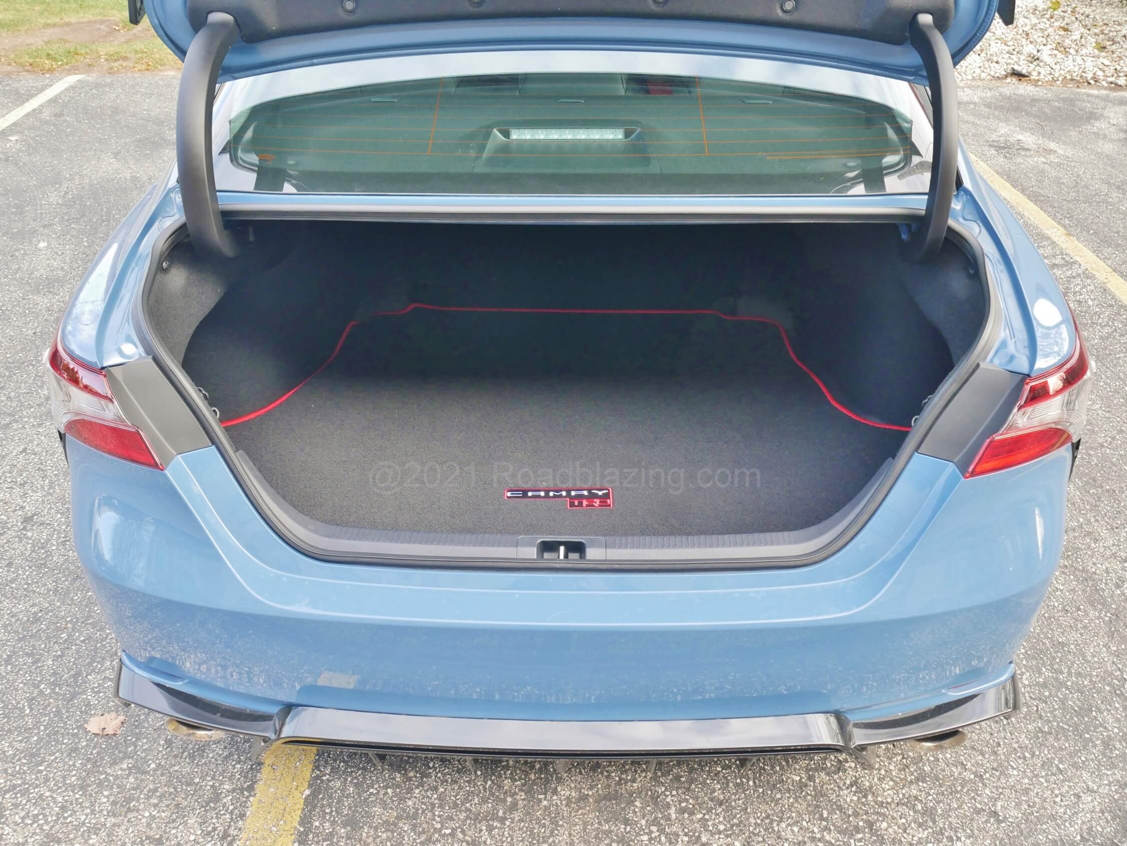 2022 Toyota Camry TRD: ample trunk with "TRD" lettered load floor mat, but rear cabin bracing eliminates trunk to cabin access
