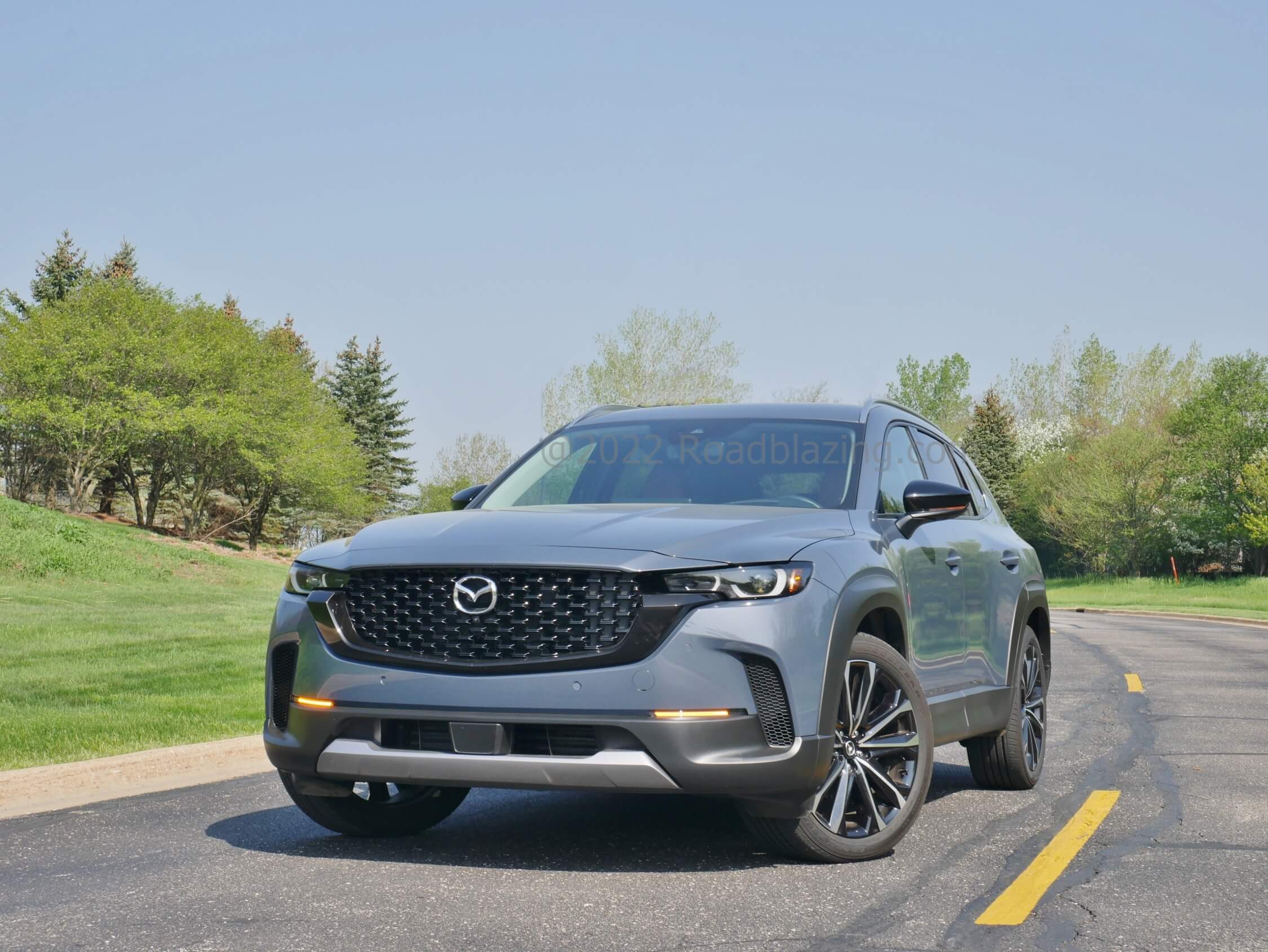 2023 Mazda CX-50 2.5 Turbo: Wider stance enhanced by darkened wider slimmed grille, bolder fenders & corner fangs allowing brake cooling.