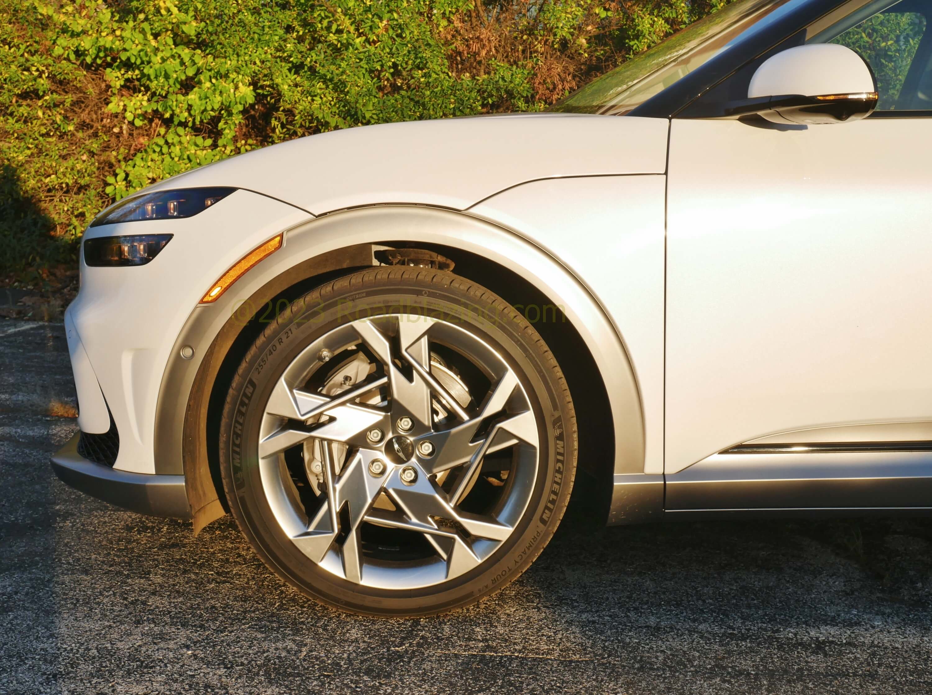 2022 Genesis GV60 Performance AWD EV: nearly 5000 lbs are tautly sprung on 21" wheels for a premium sport ride with formidable 4-piston front brake calipers.