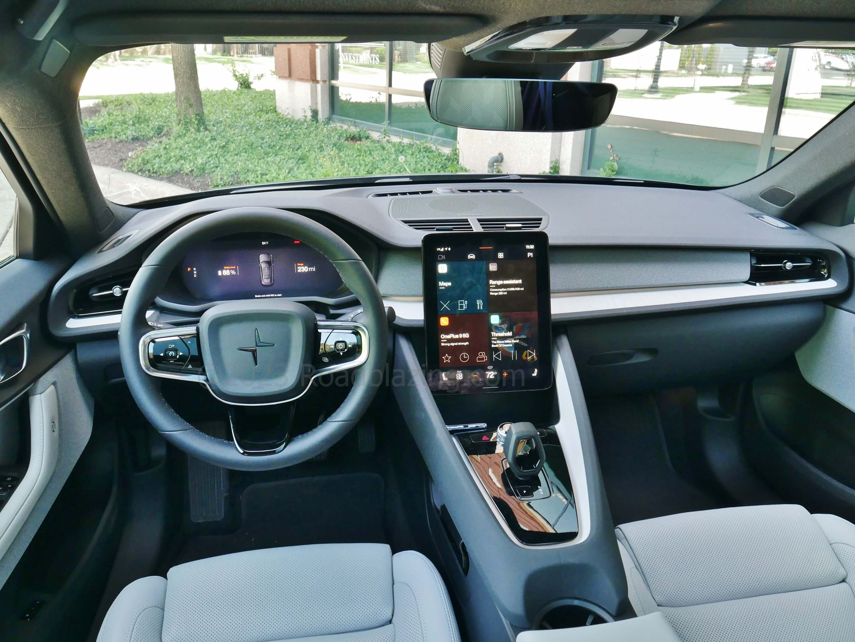 2023 Polestar 2 Dual Motor: large portrait gauge cluster + portrait touch infotainment displays dominate a warmer for Scandinavian cockpit.