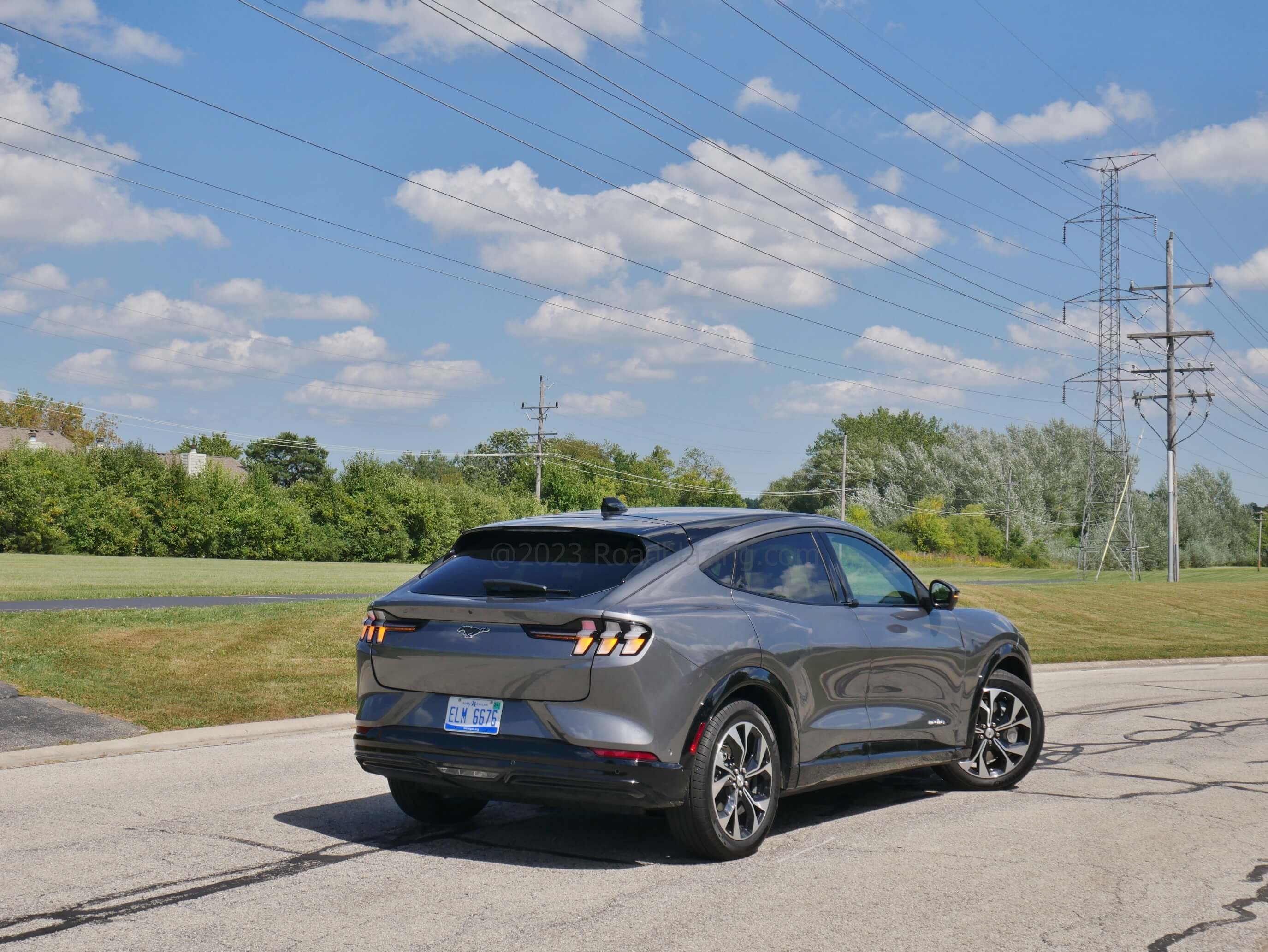 2023 Ford Mustang Mach-E Premium AWD: elements from the storied ICE powered sport coupe include fastback look and outboard segmented arrow rear directionals.