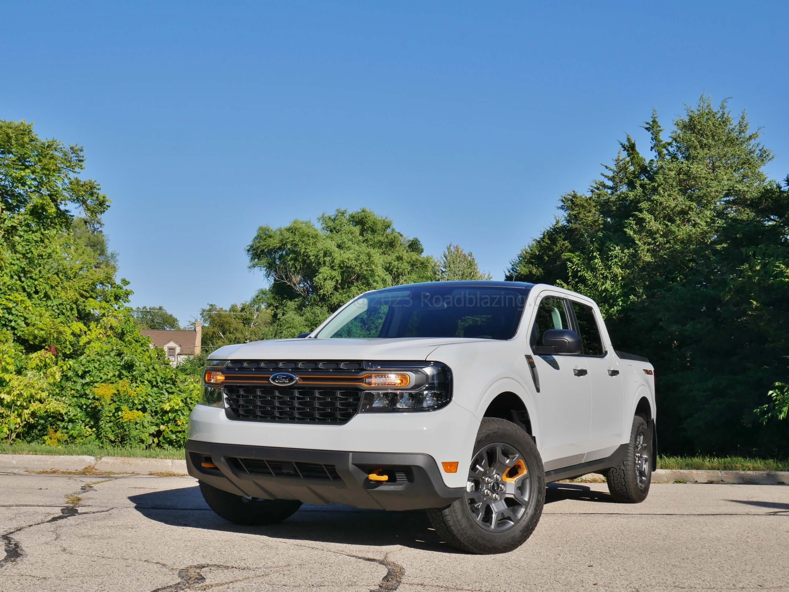 2023 Ford Maverick XLT Tremor AWD: orange front tow hooks, grille bar and wheel spoke