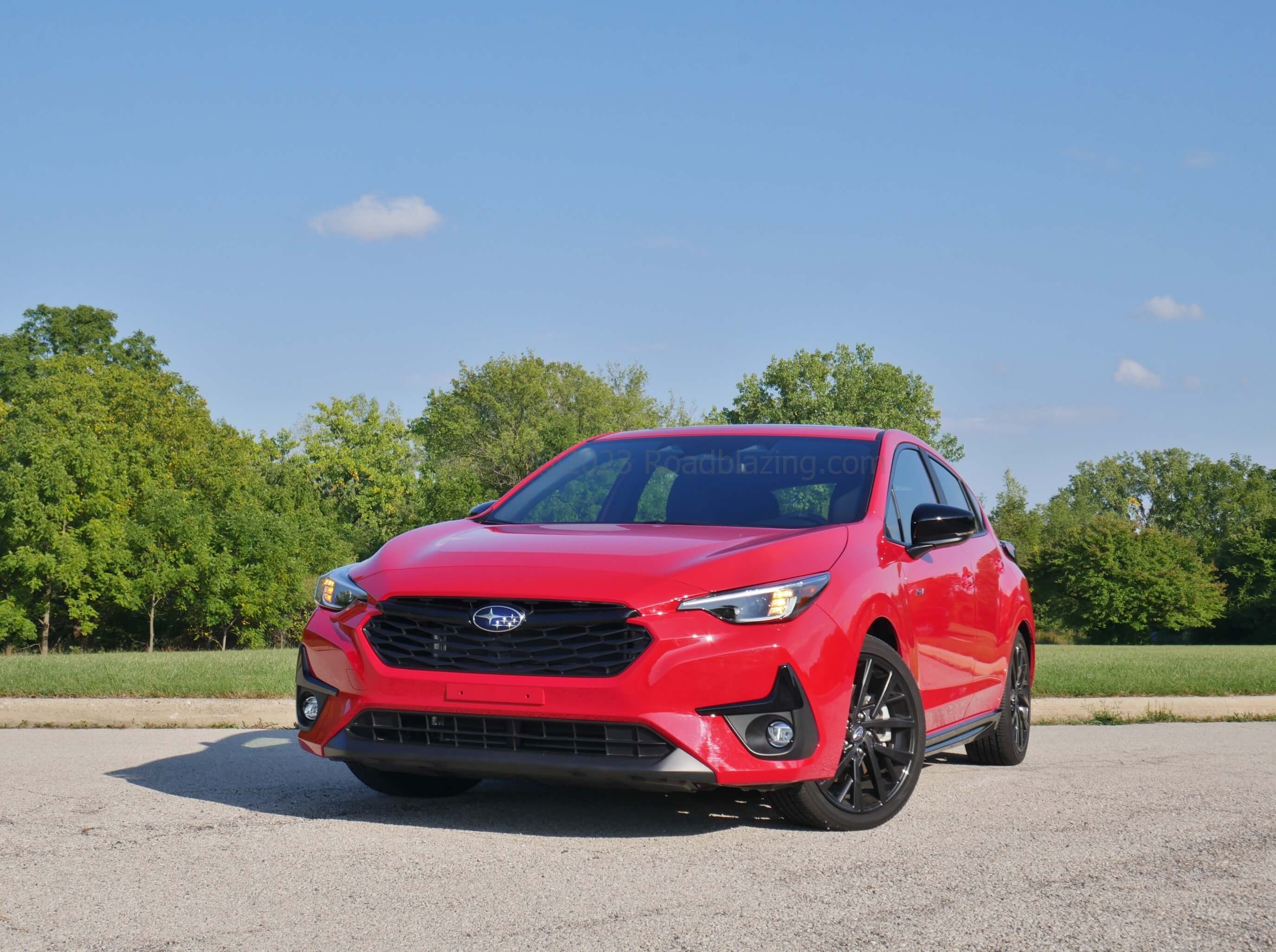 2023 Subaru Impreza RS: aggressive front air dam & corner creases with restrained darkened lattice hexagon grille