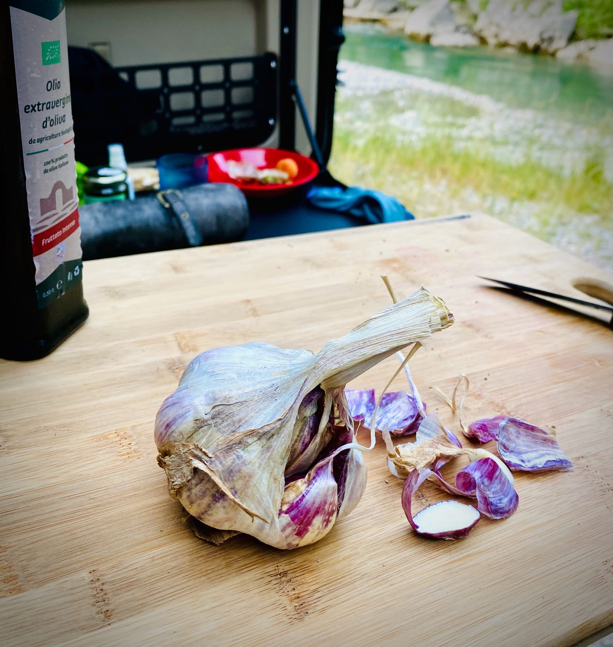 A head of freshly cut garlic on a chopping board