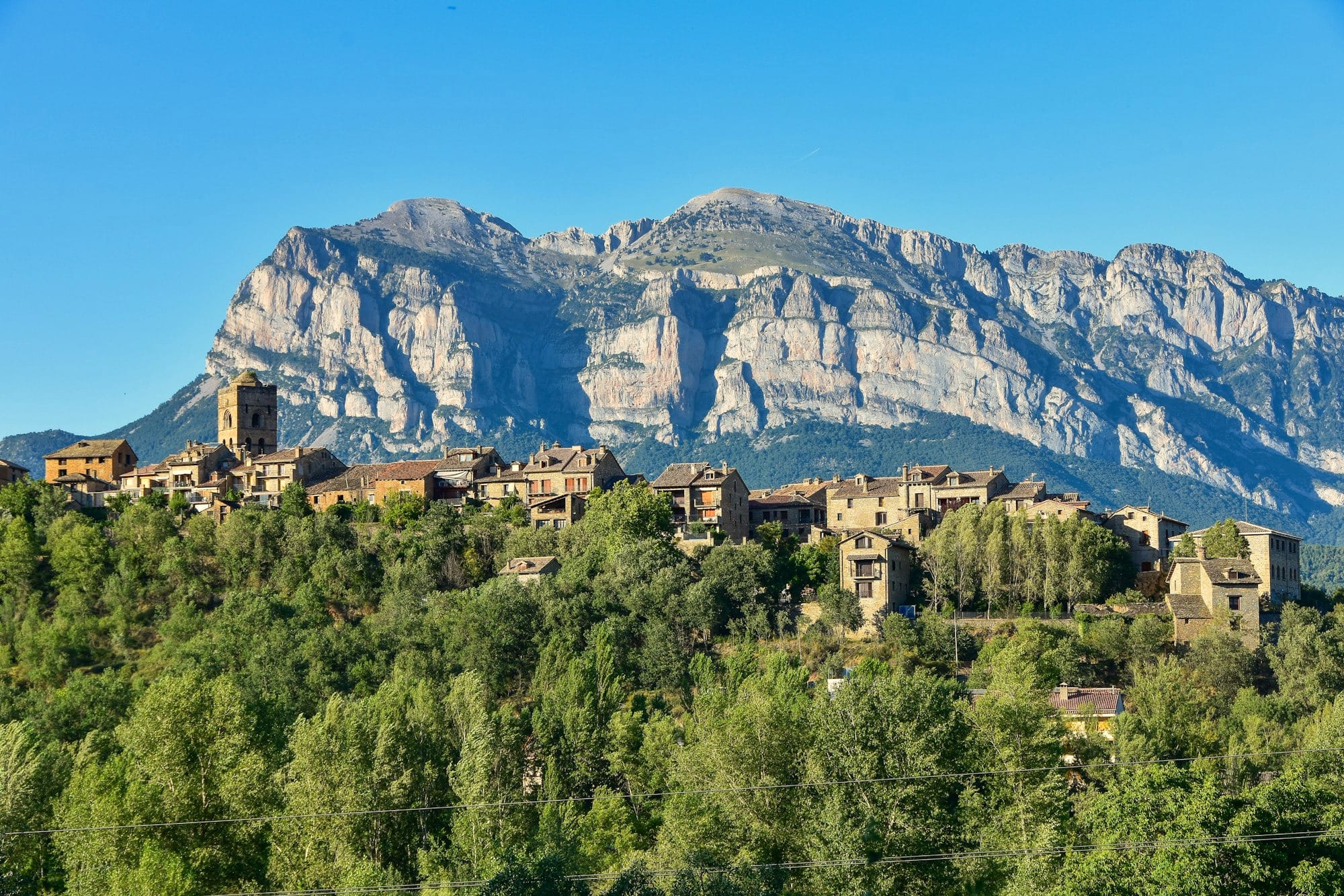 A village in the foreground and with mountains of the Spanish Pyrenees in the background