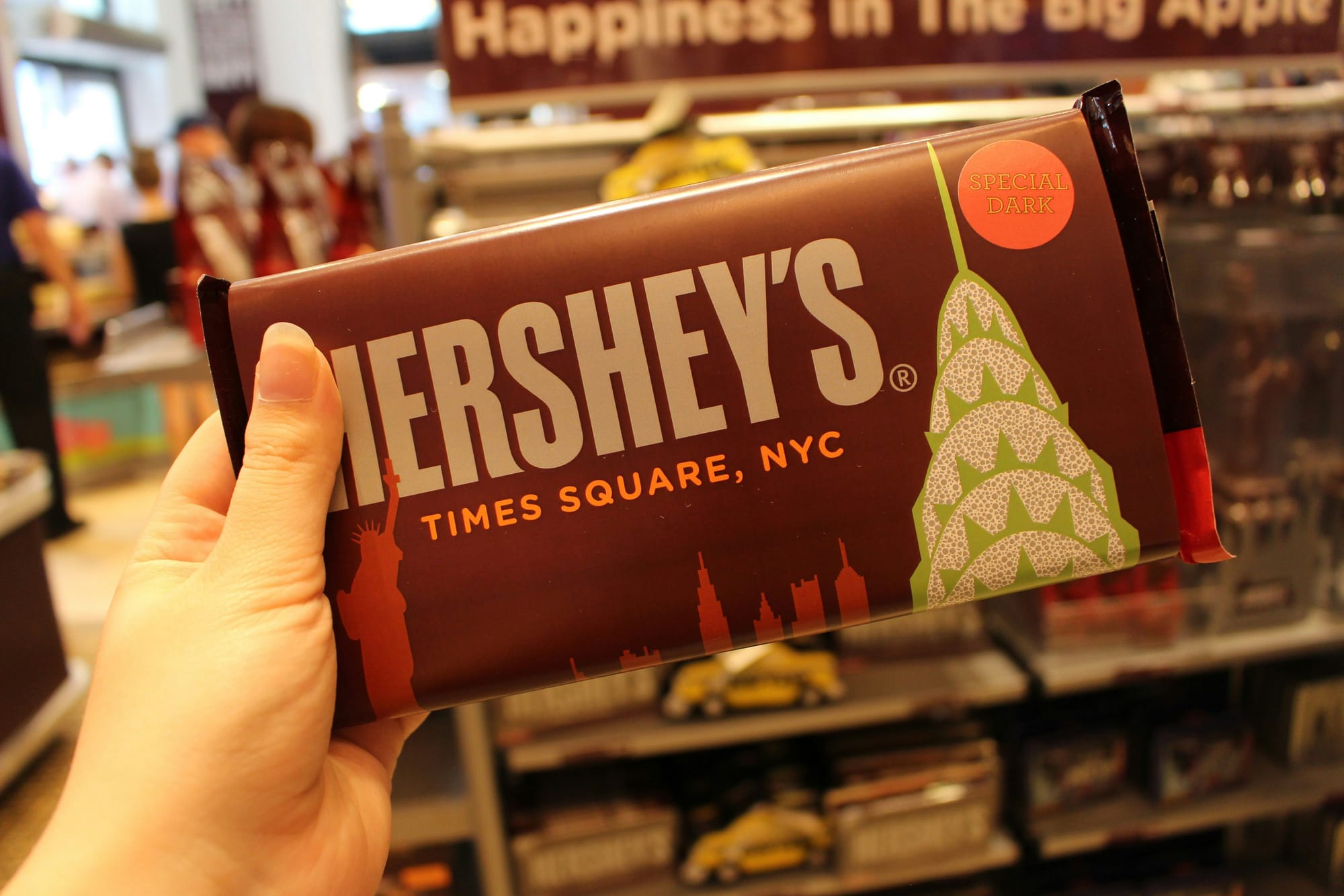 Image shows someone holding a chocolate Hershey bar
