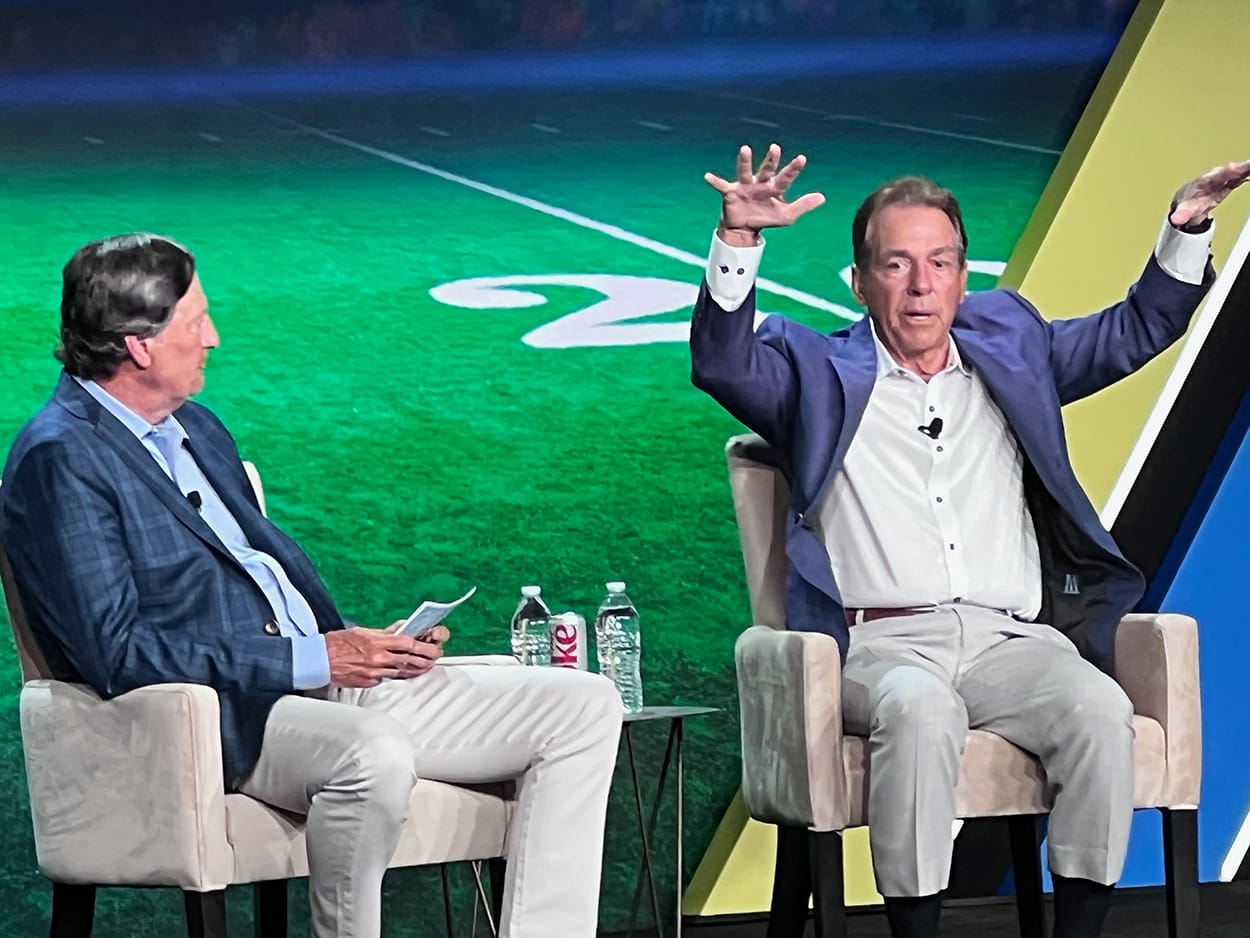 Image shows football coach Nick Saban chatting to John Downs at SOTIC