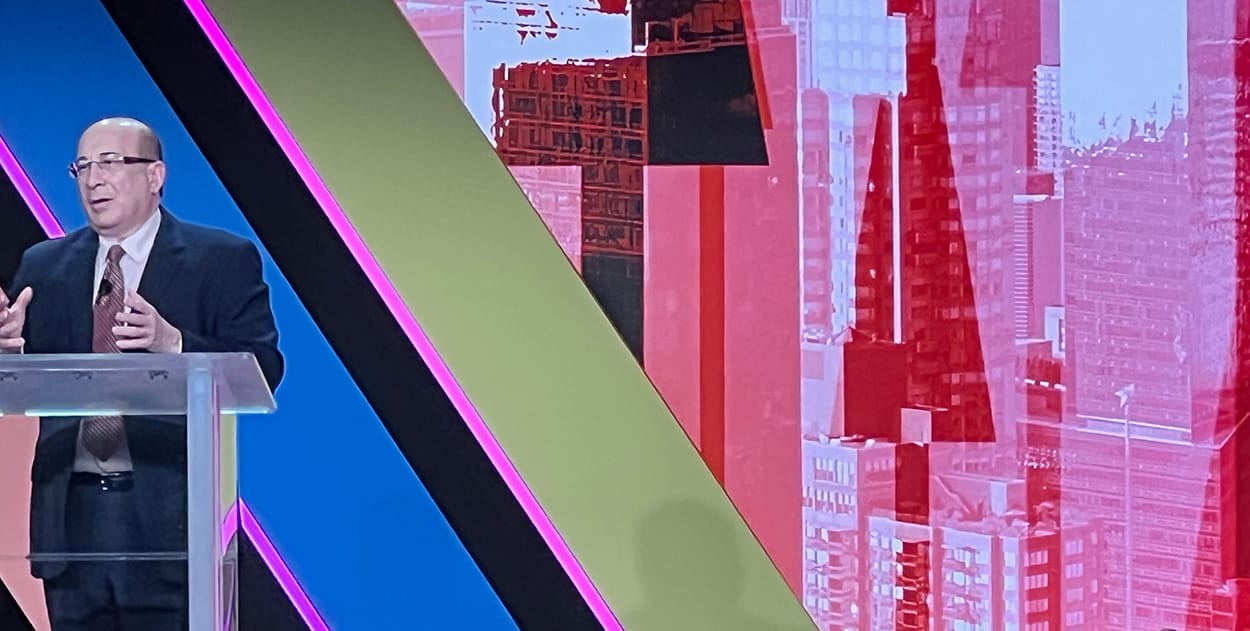 Image shows CNBC analyst Ron Insana addressing delegates at SOTIC.