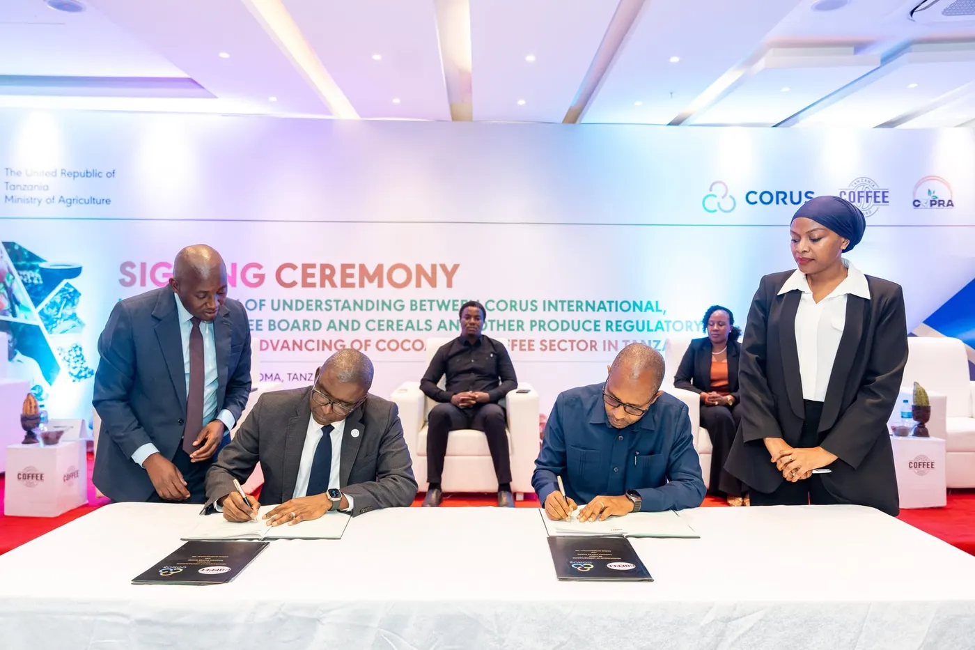 Image shows representatives of Corus International and the TCB signing the MOUs to boost the country's production of cocoa and coffee
