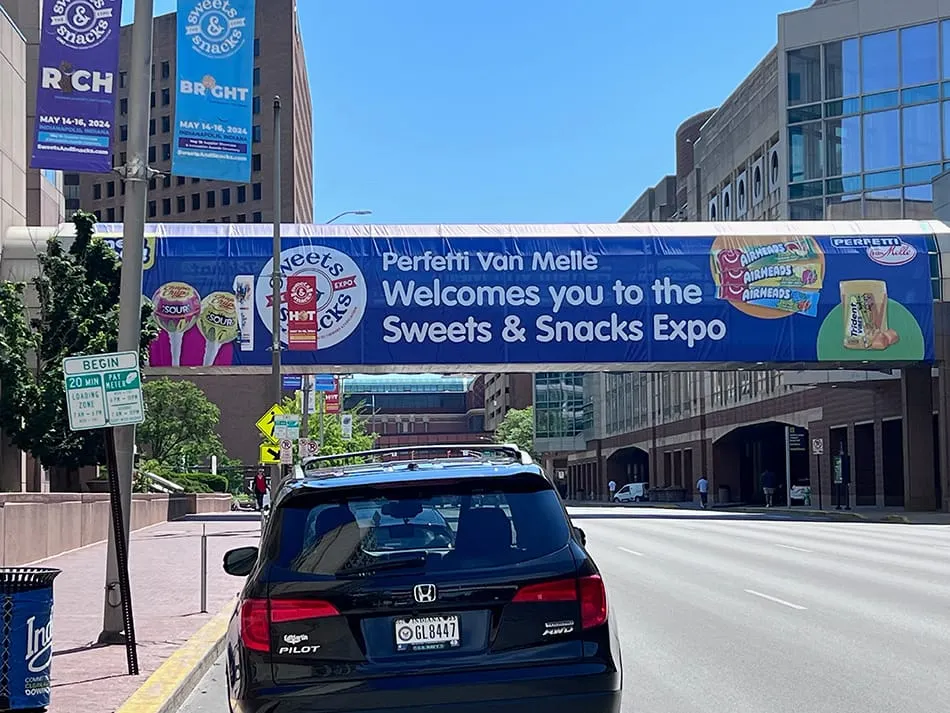 Image shows banner across a street advertising the Sweets & Snacks Expo in Indianapolis.
