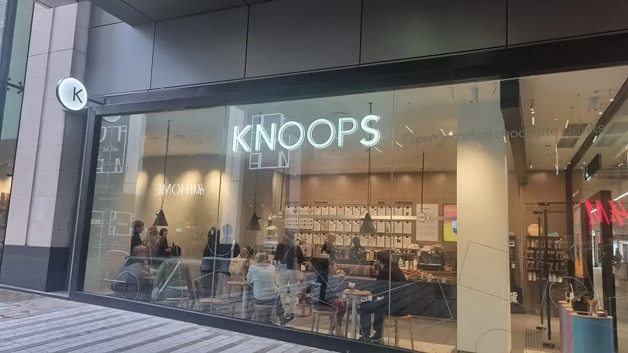 Image shows an exterior shot of a Knoops cafe.