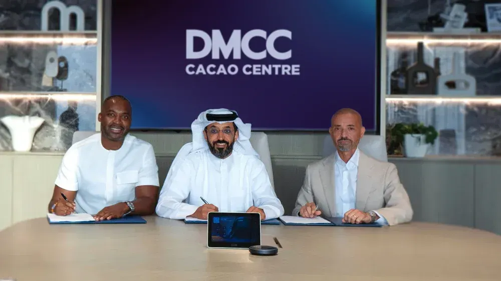 Image shows Ahmed Bin Sulayem, Executive Chairman and Chief Executive Officer of DMCC signing the agreement with representatives of Kumbi Cocoa and Ribezzi Group.